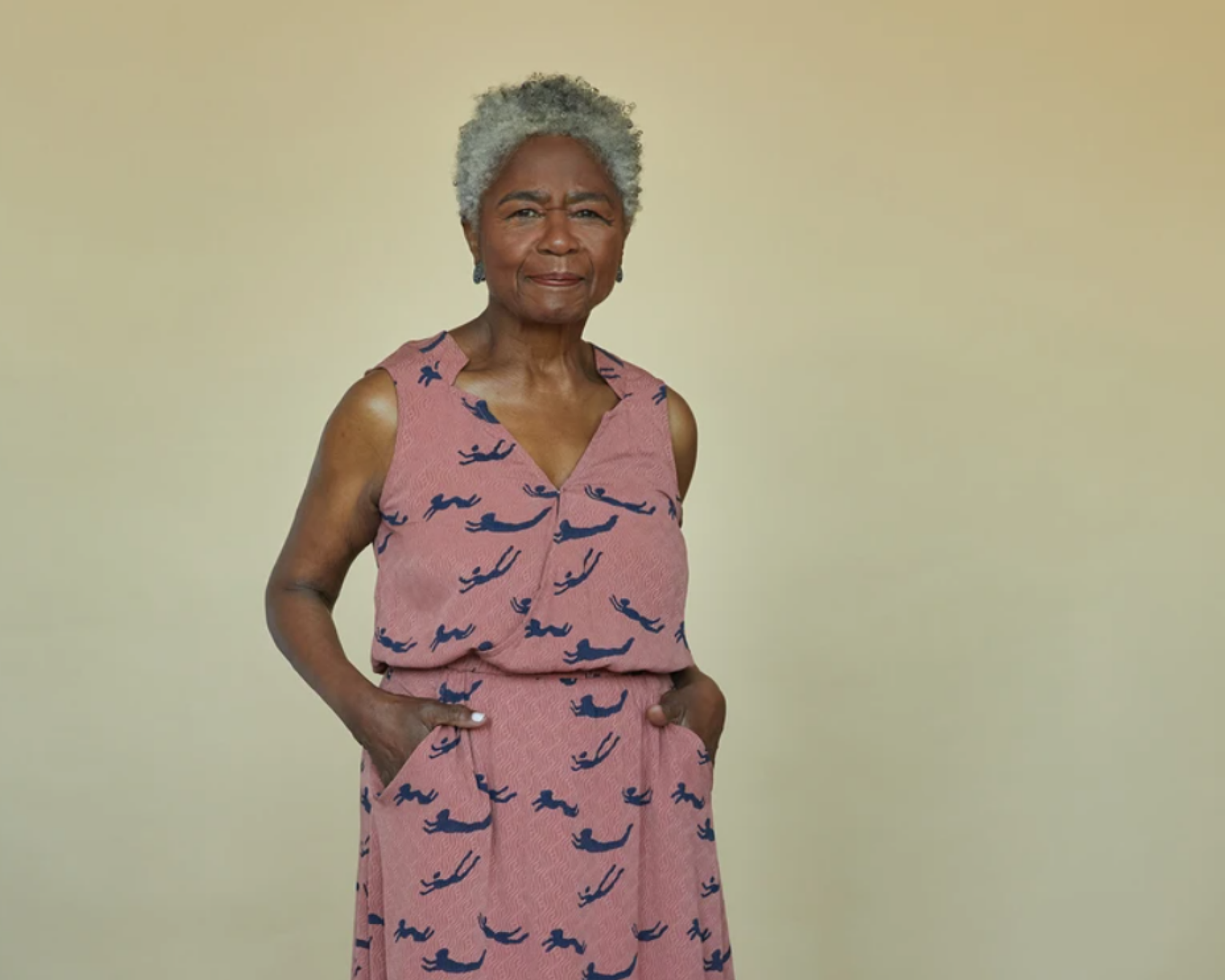 elderly woman of colour wearing sustainable silk dress in pint by Seek Collective