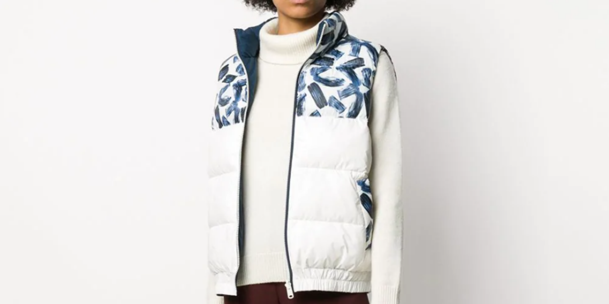 woman of colour wearing reversible recycled polyester vest from Ecoalf via Farfetch