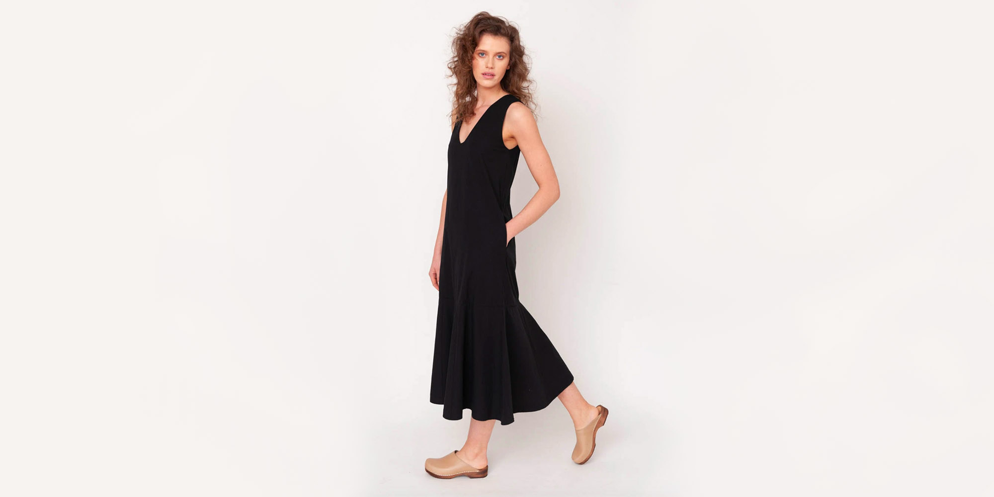 woman wearibg black organic cotton dress from beaumont organic