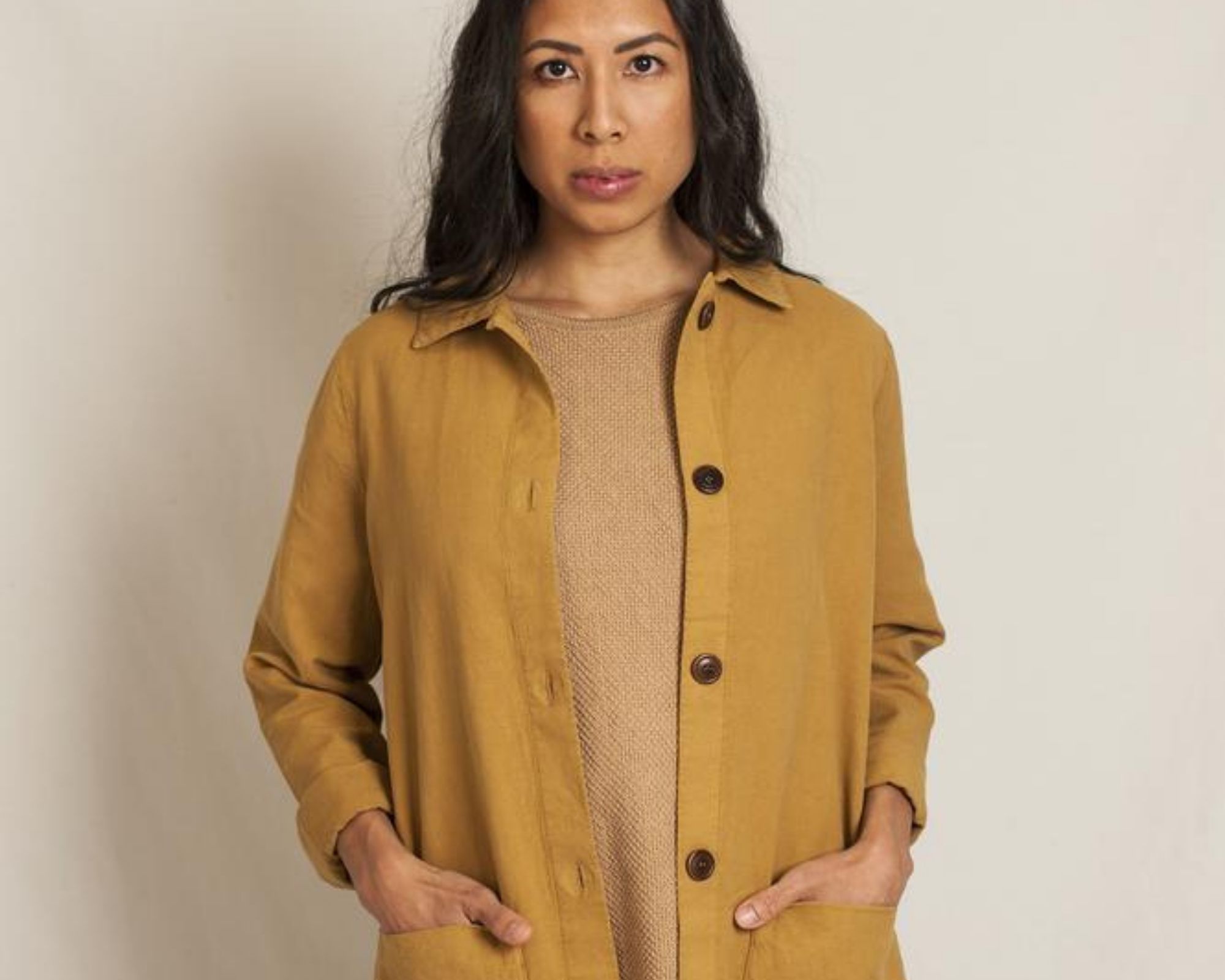 woman of colour wearing mustard organic hemp jacket from L'Envers