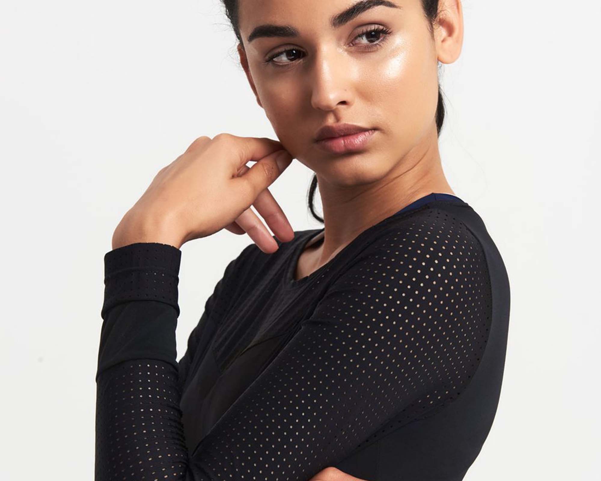 feature image woman wearing black adrenna top