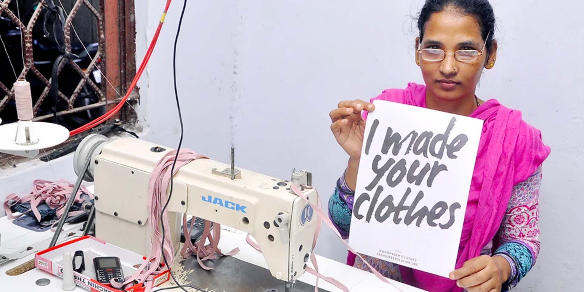 woman in ethical brand underprotection's factory with a sign saying I made your clothes