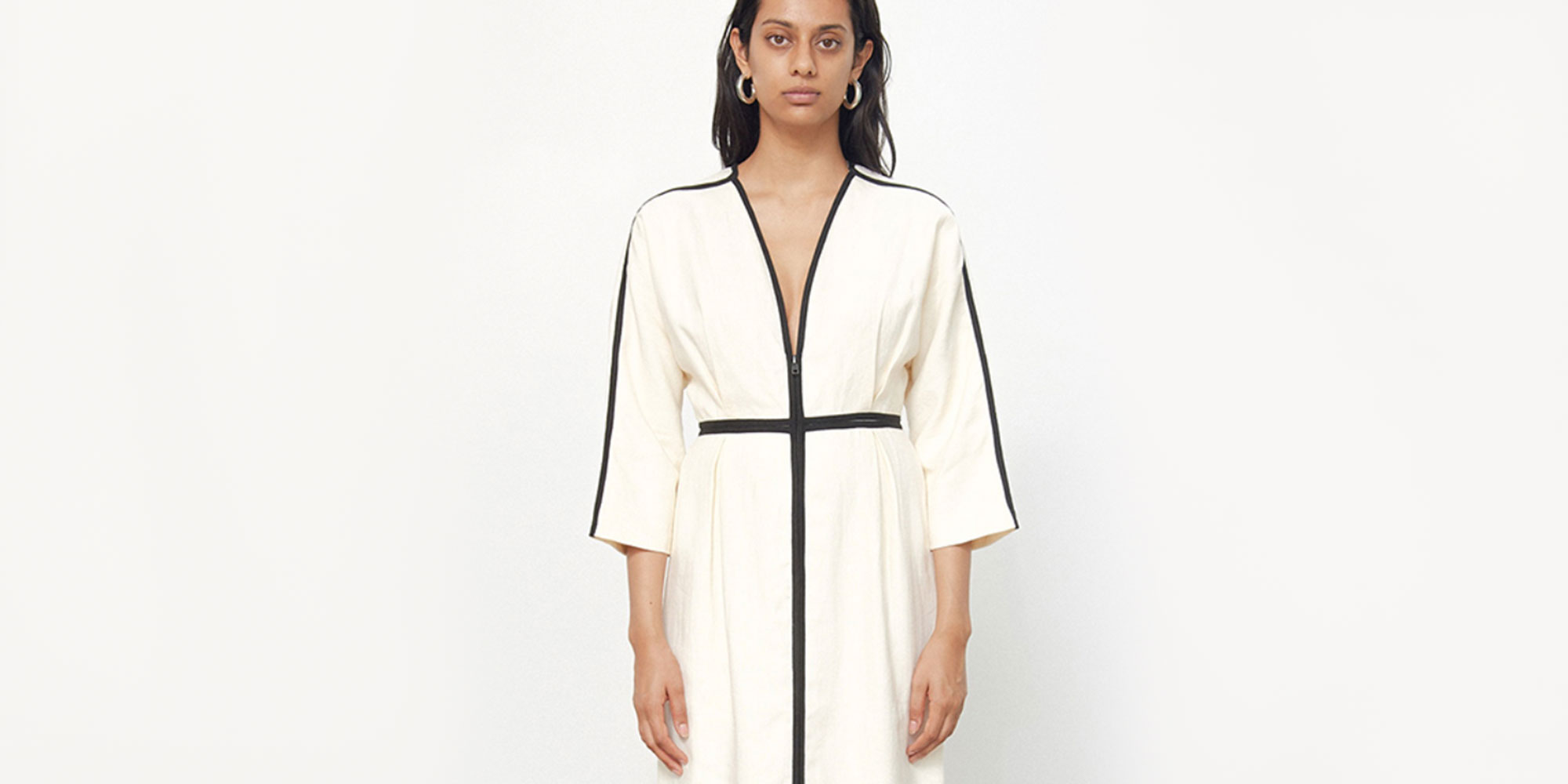 woman wearing black and white linen dress by mara hoffman