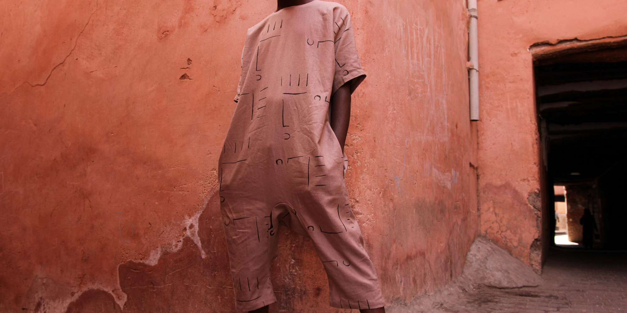 man of colour wearing sustianably made hemp jumpsuit by Chelsea Bravo
