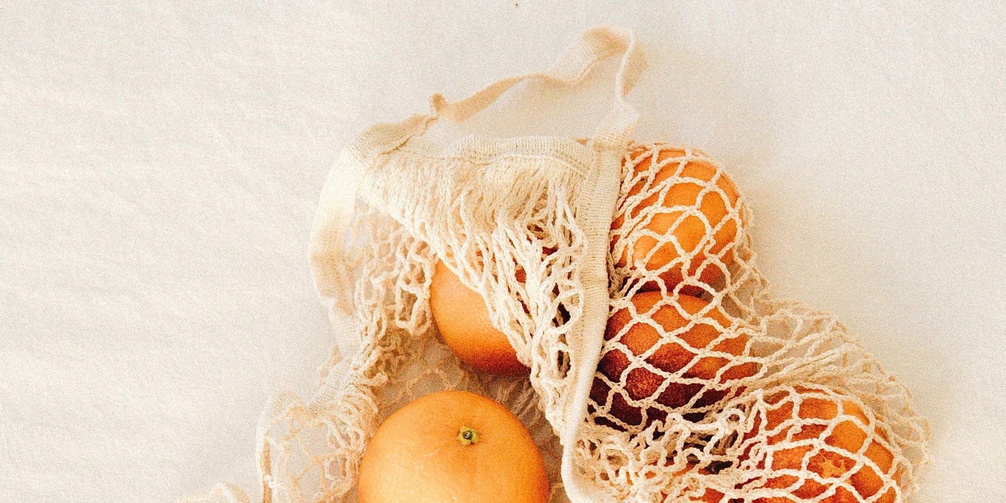 bag of oranges in reusable bag for plastic free july