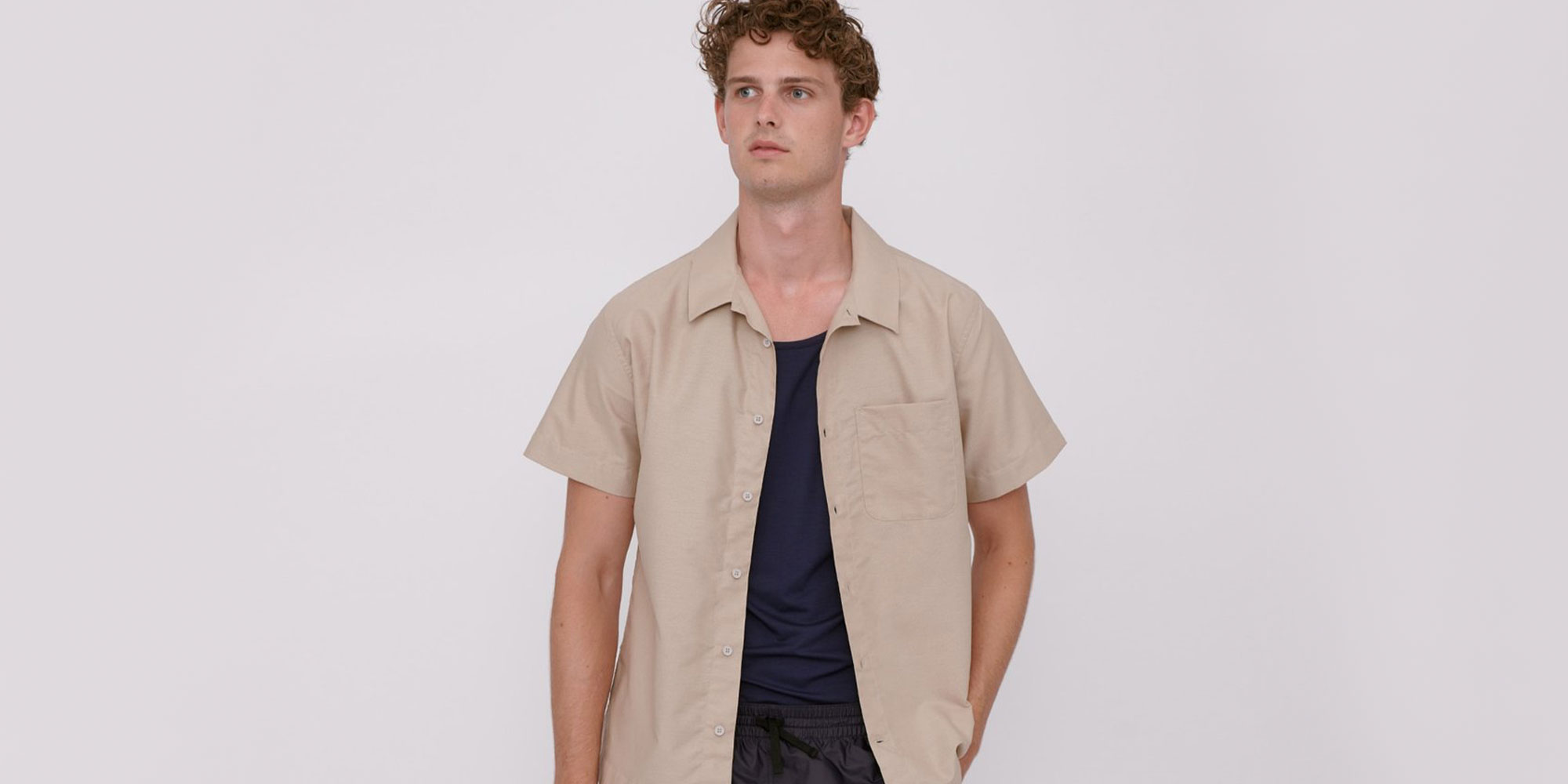 man wearing beige ethical shirt by organic basics