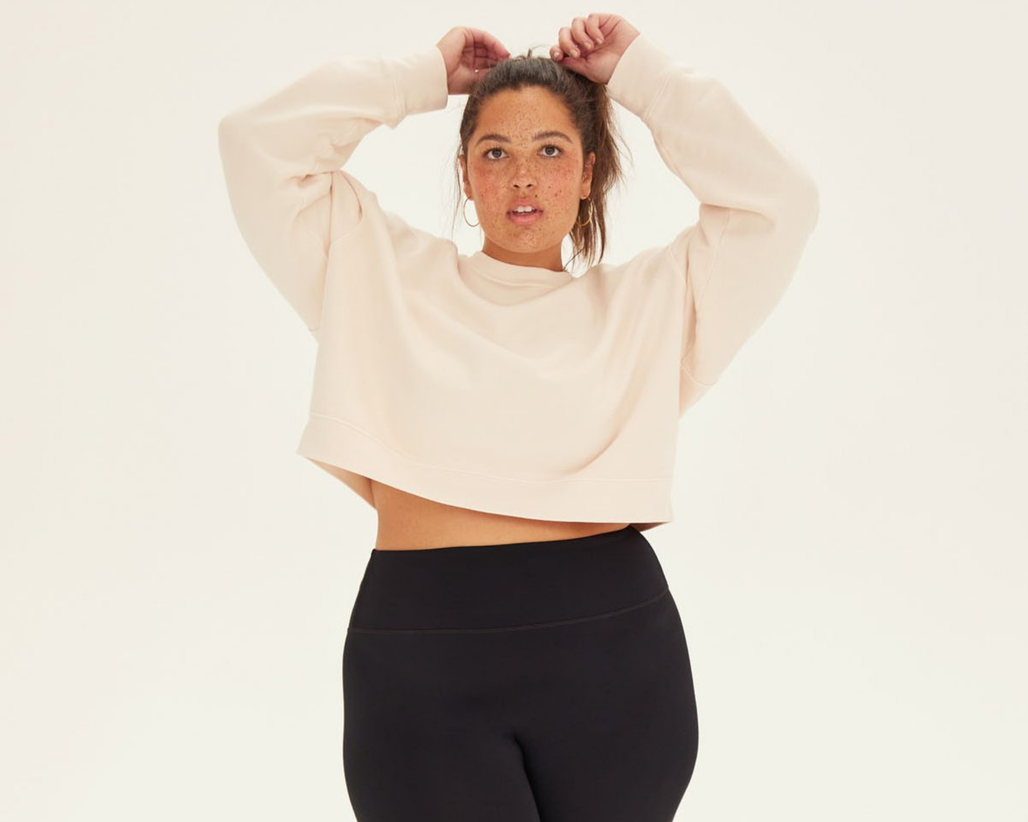 woman wearing plus size sustainable leggings from ethical brand Girlfriend Collective