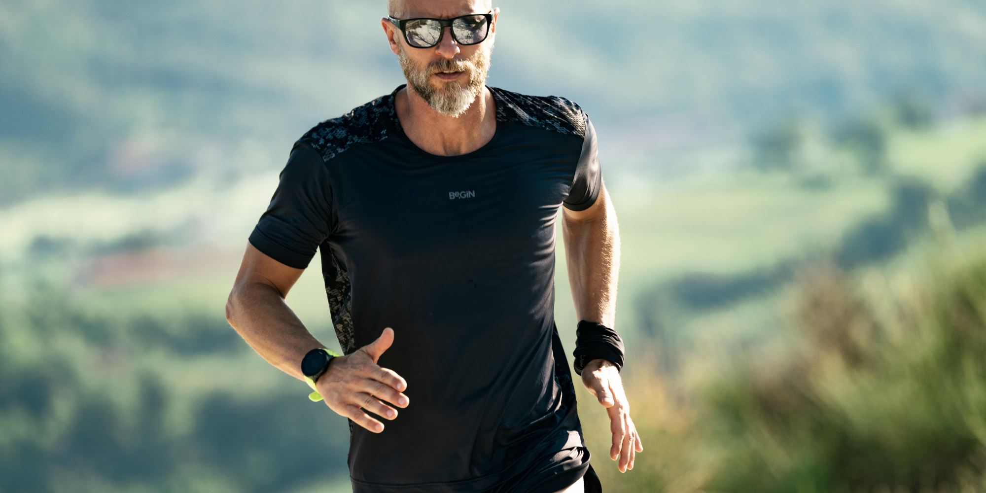 man running wearing black eco-friendly activewear by CasaGIN