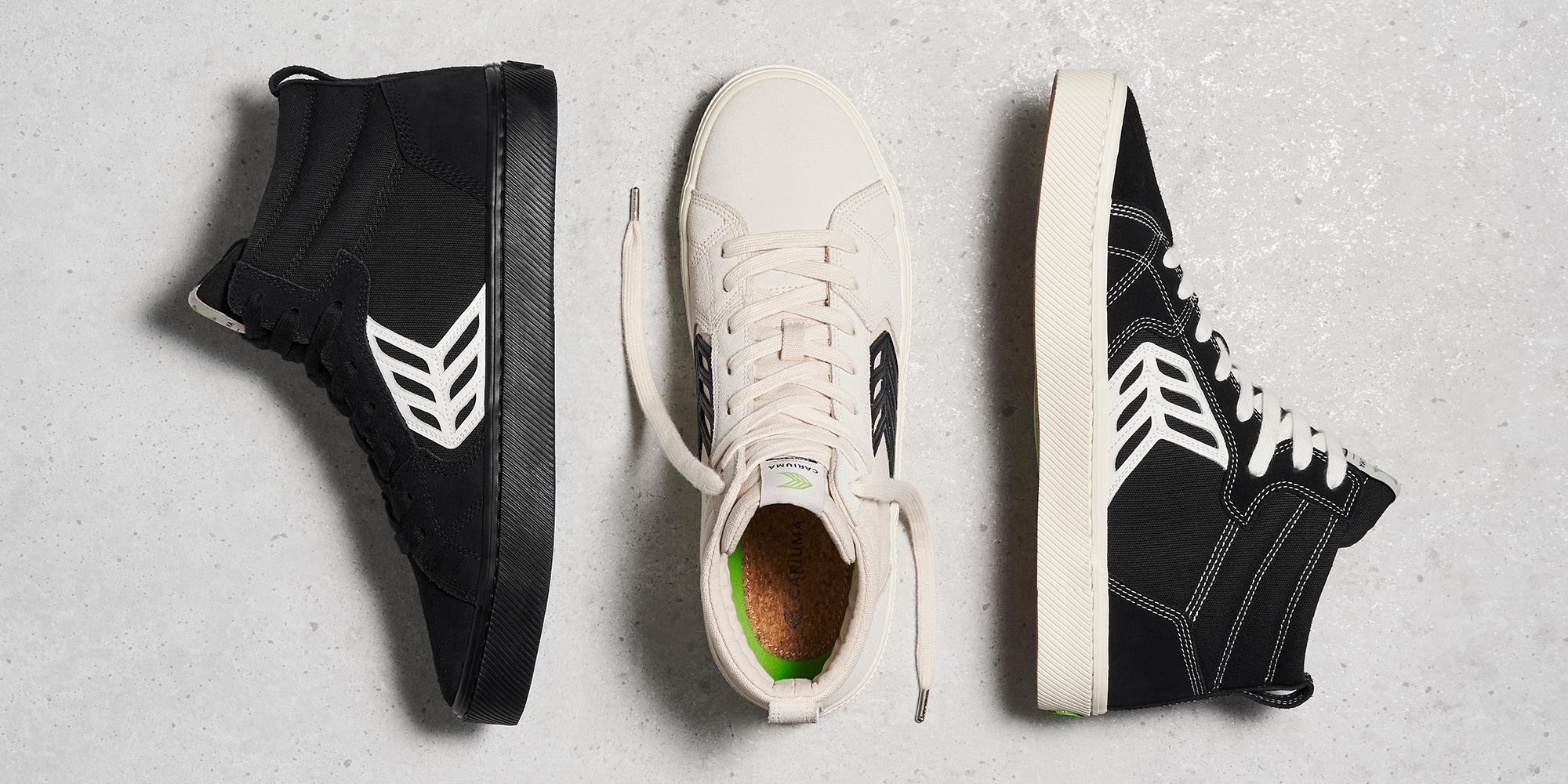 three black and white sustainable skate sneakers laying on the ground by Cariuma