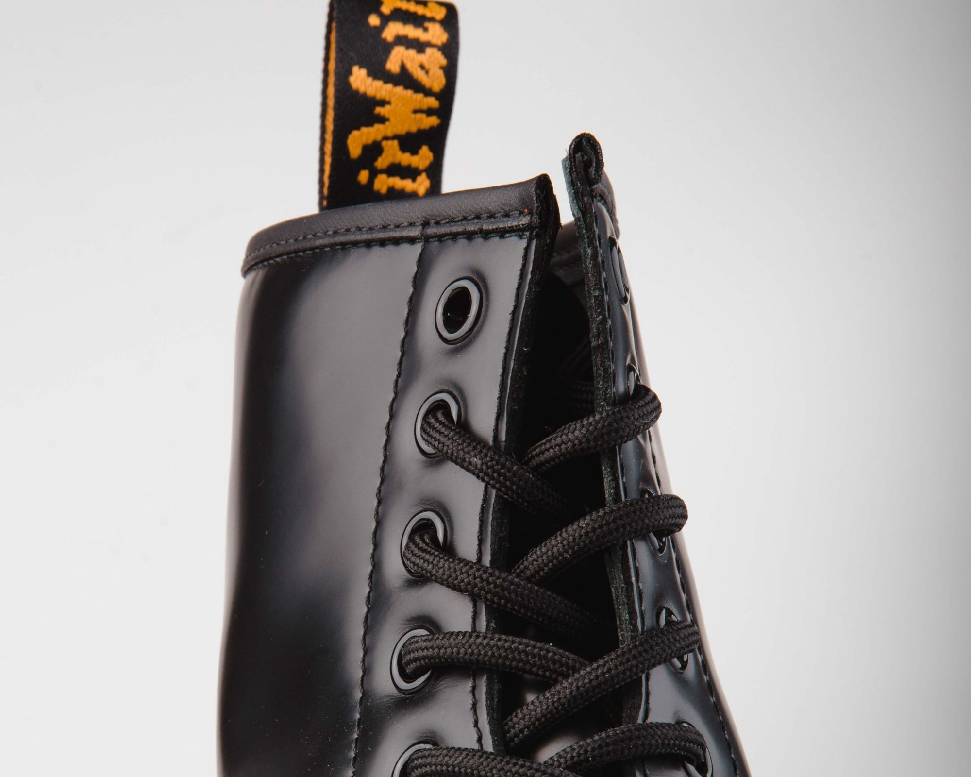 Close up of the top of a black pair of Dr Martens boots.