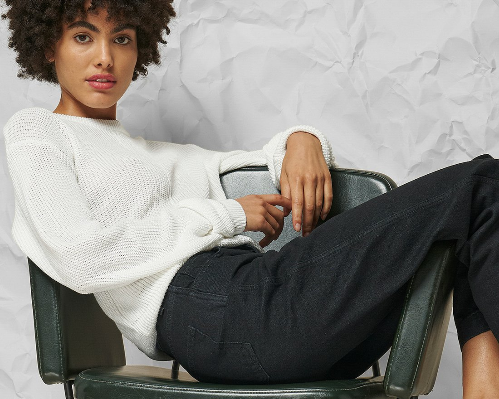 black woman with afro wearing nu-in circular denim jeans and white top