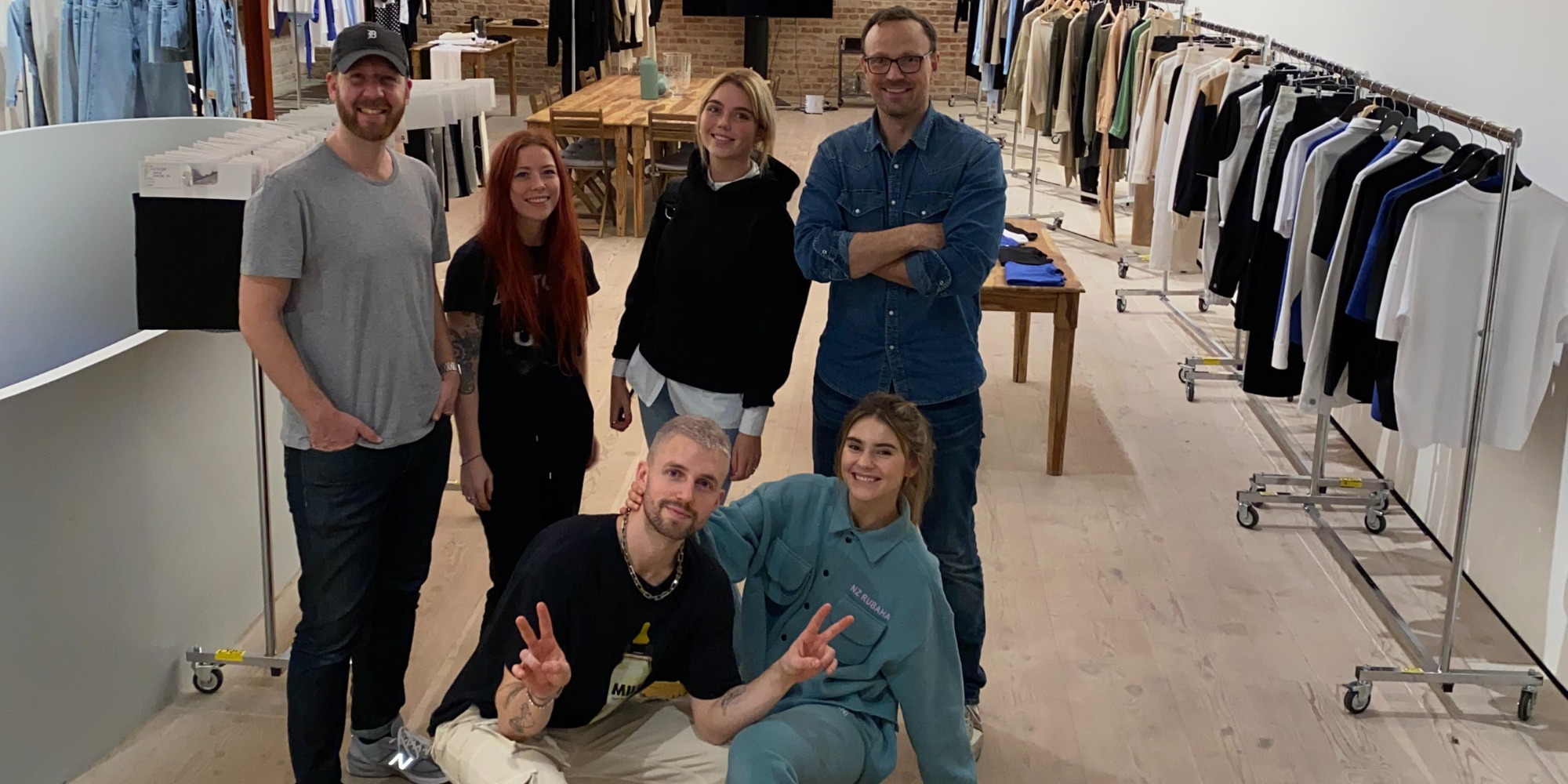 nu-in founders all together next to garment racks