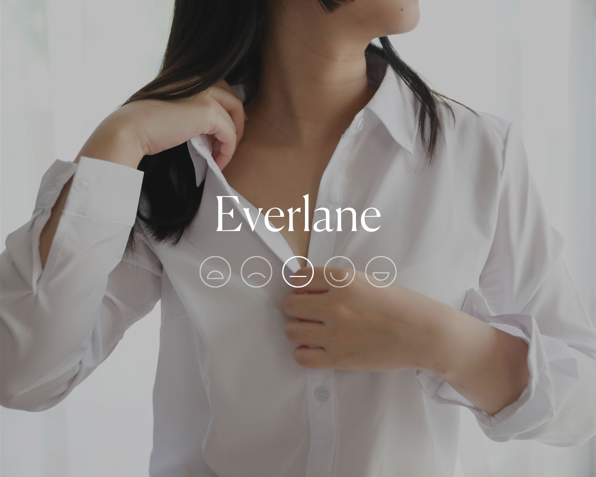 Someone wearing a basic white blouse with the word Everlane and a flat-mouthed emoji highlighted in which on top of the image.