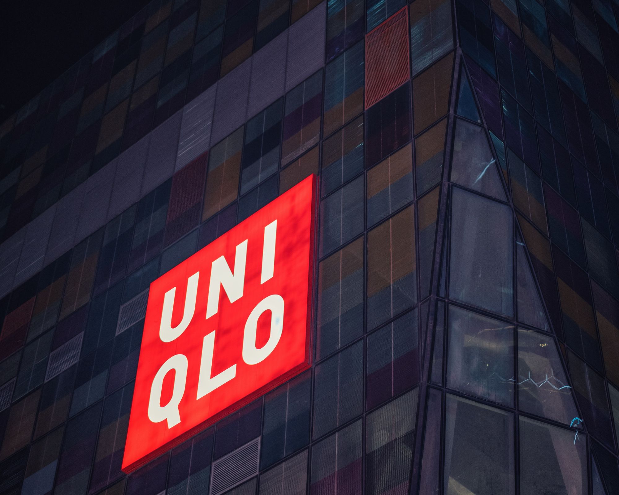 A big red UNIQLO sign on the side of a building.