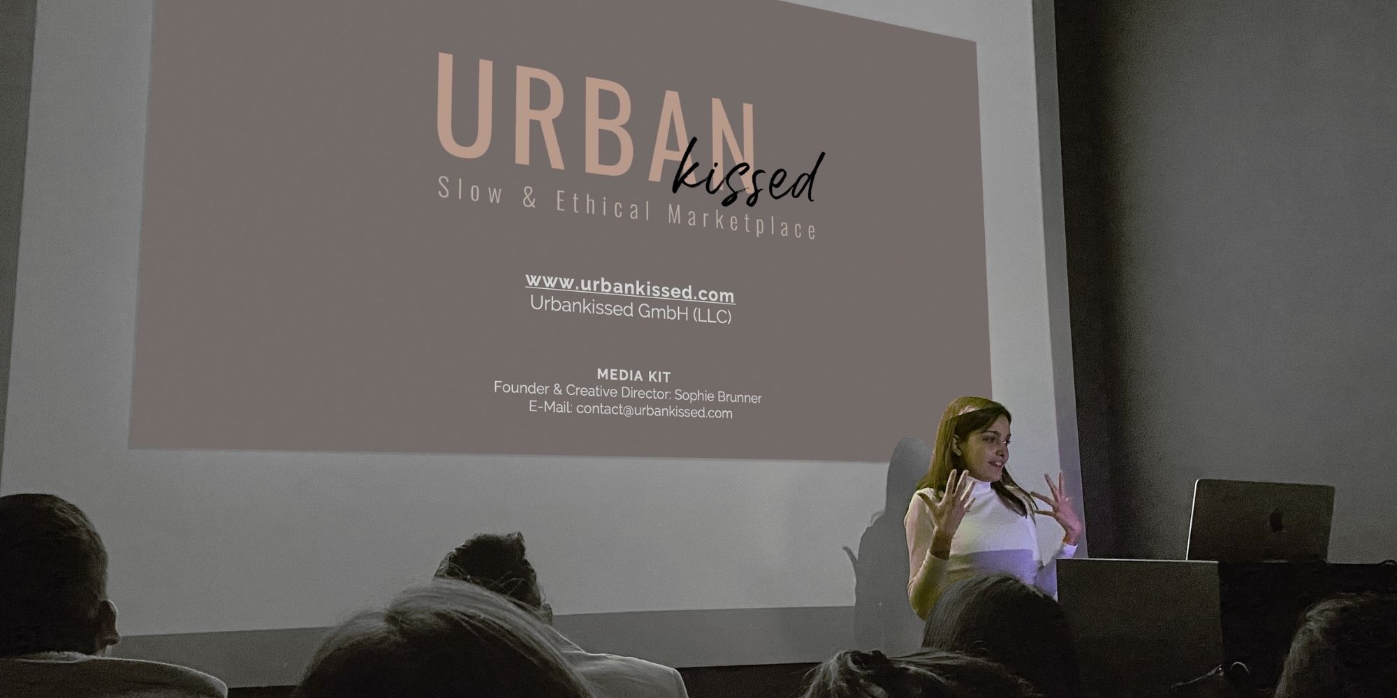 Urbankissed founder Sophie Brunner standing in front of a business presentation