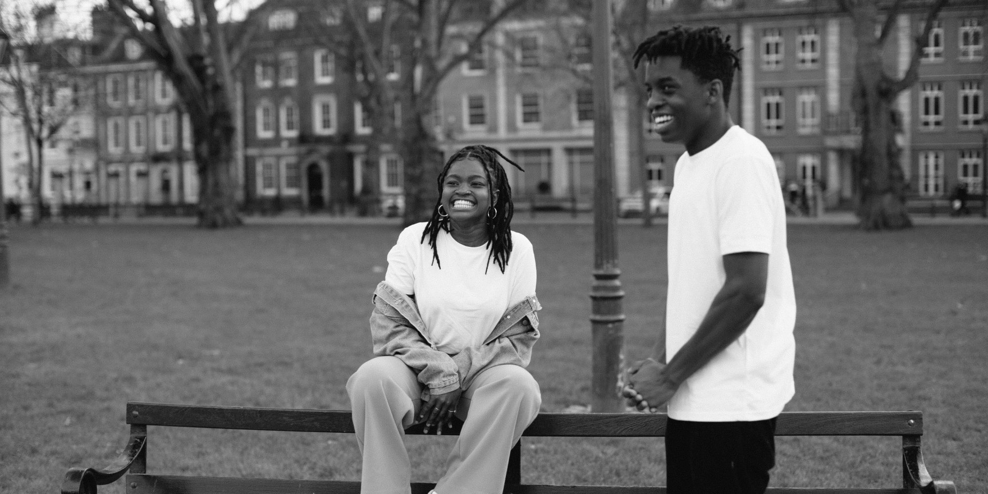 black and white shot of black woman and man wearing white ethical tees by Yes Friends