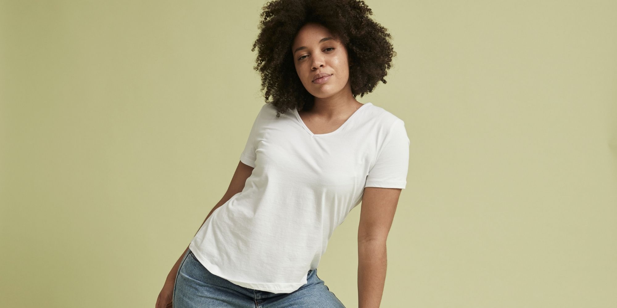 woman of colour wearing white sustainable tshirt designed by Citizen Wolf