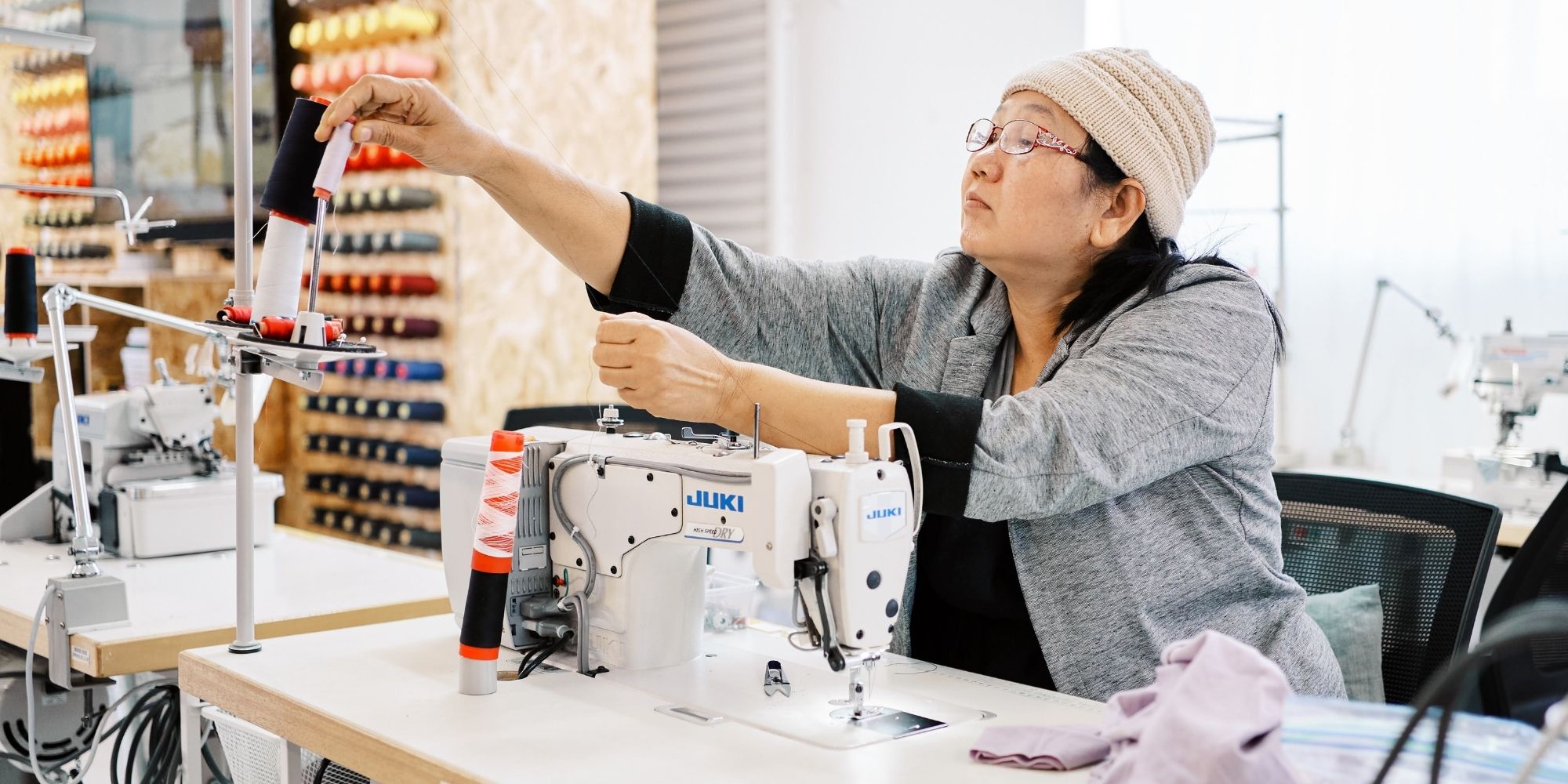 woman sewing in Citizen Wolf ethical factory
