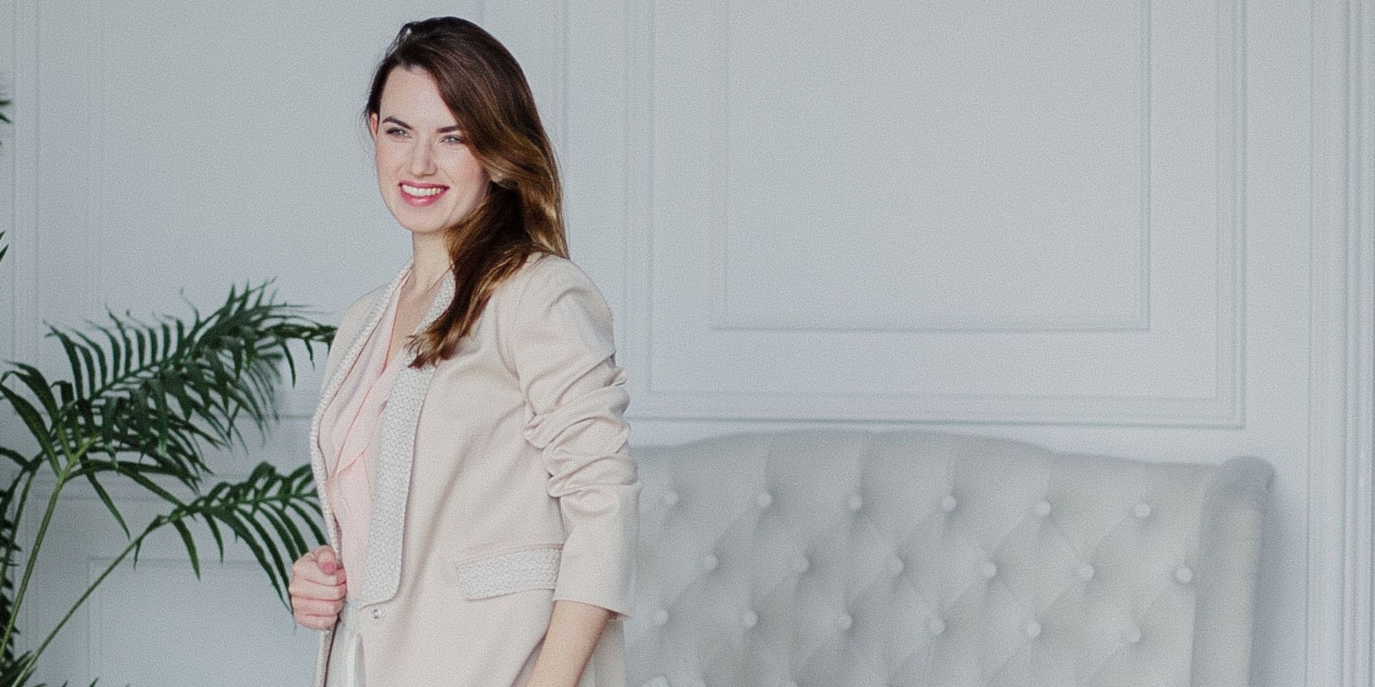 Dressarte founder Nathalie in front of a couch
