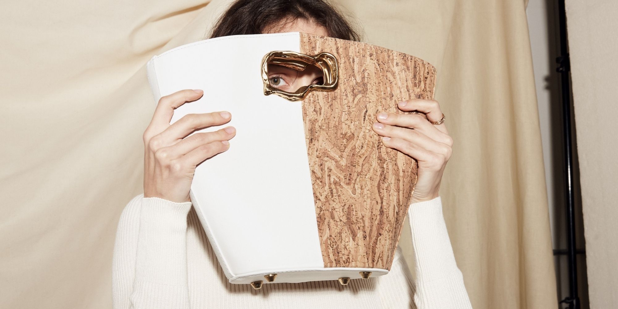 woman peering through cork and white vegan handbag by Mashu