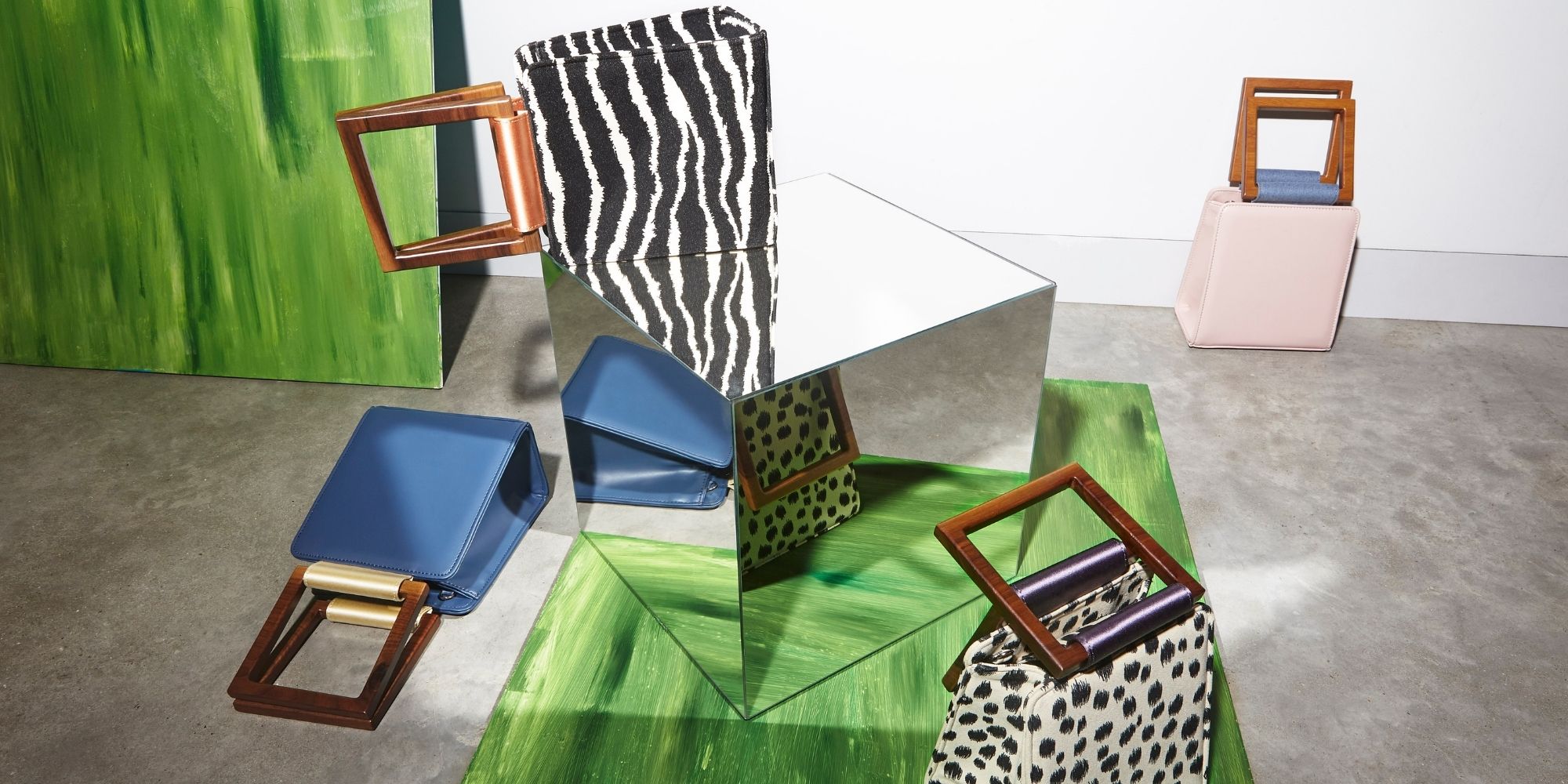 animal print sustainable handbags by Mashu placed on green mirror background