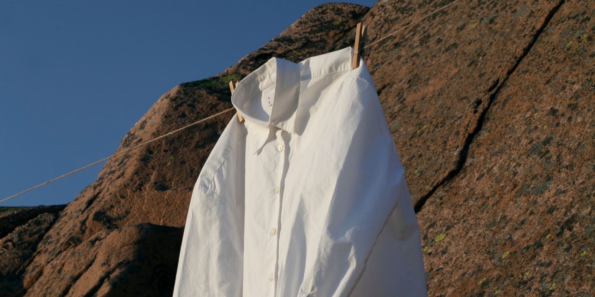 white shirt by ASKET pegged on line