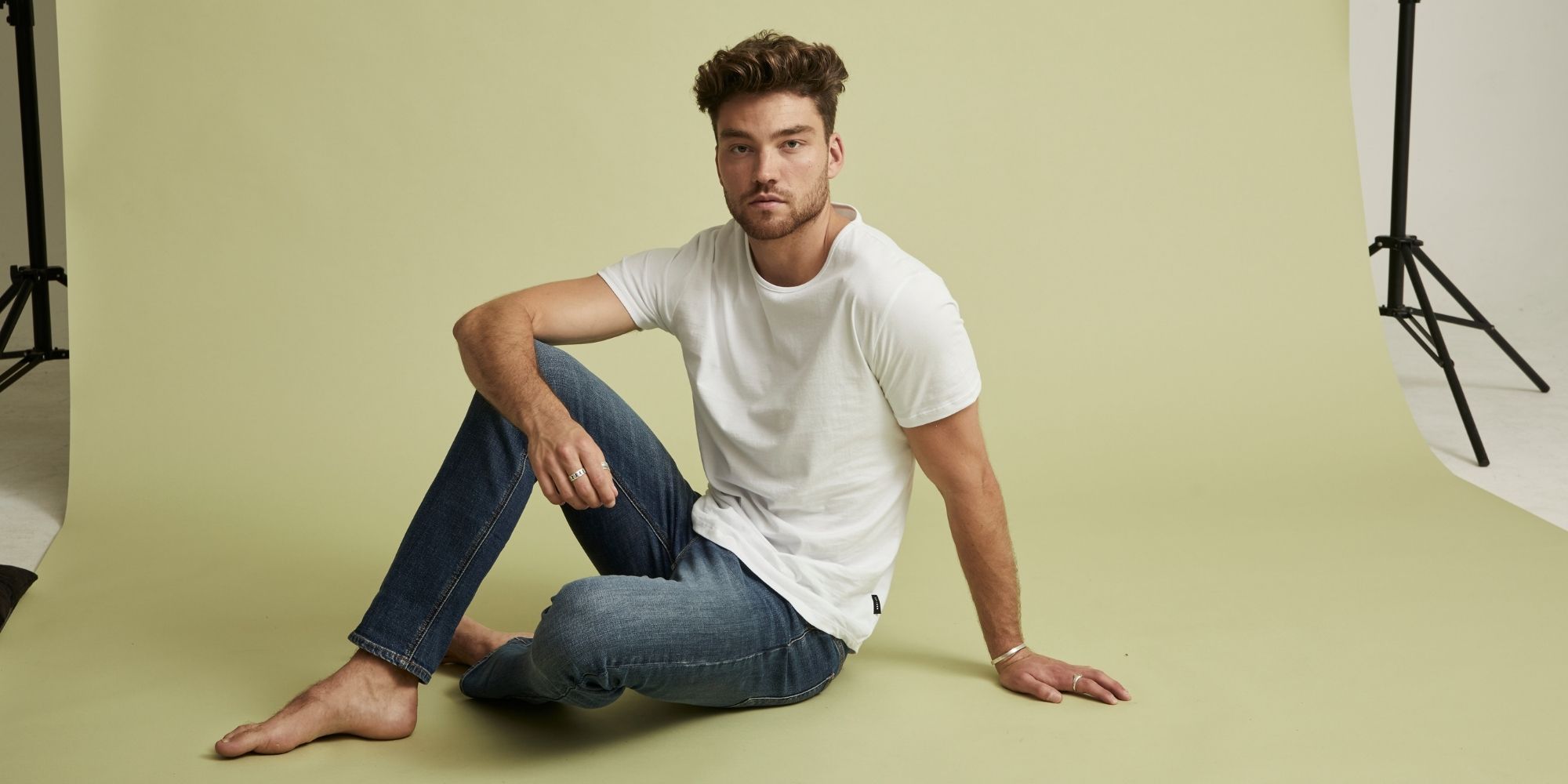 man wearing white sustainable tee by Citizen Wolf