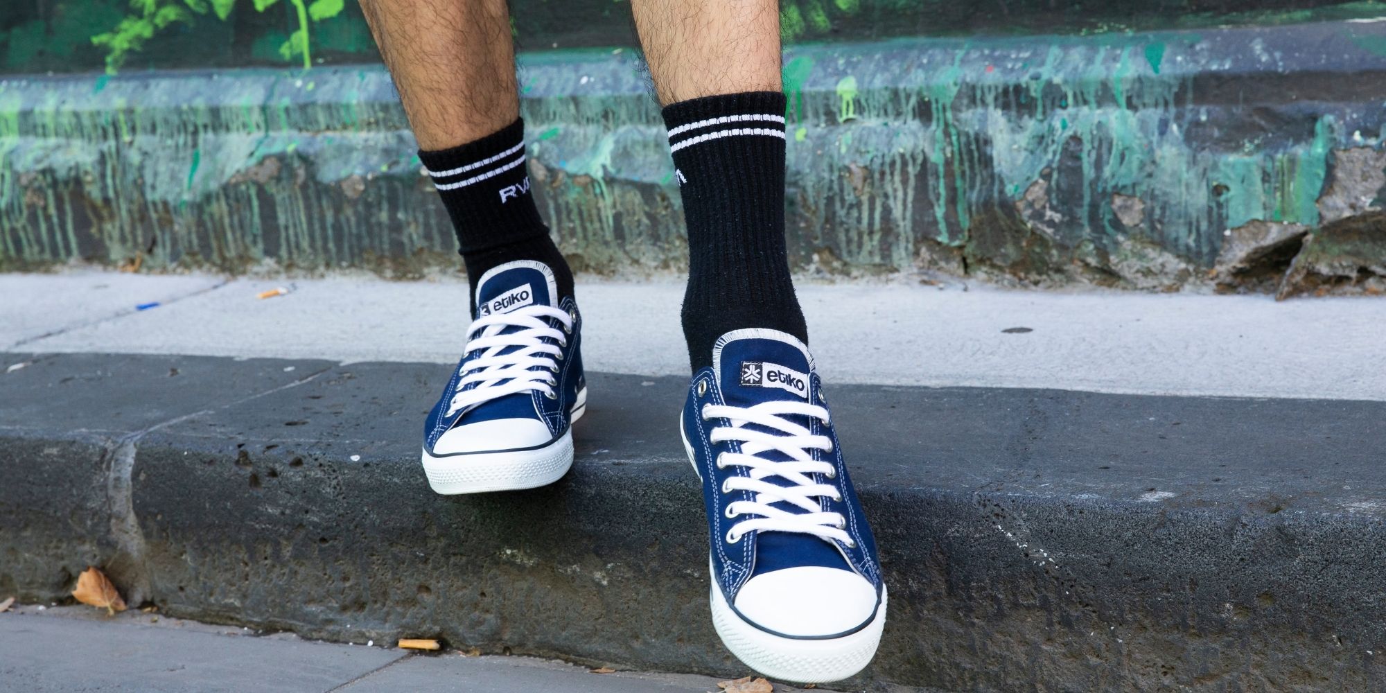 person wearing blue and white ethical sneakers by Etiko