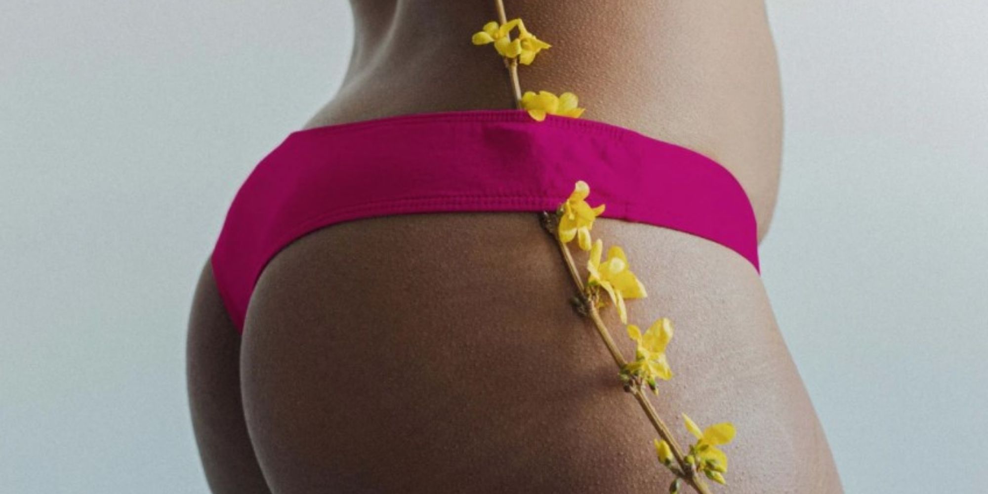 person of colour wearing bright rose organic cotton compostable underwear by KENT