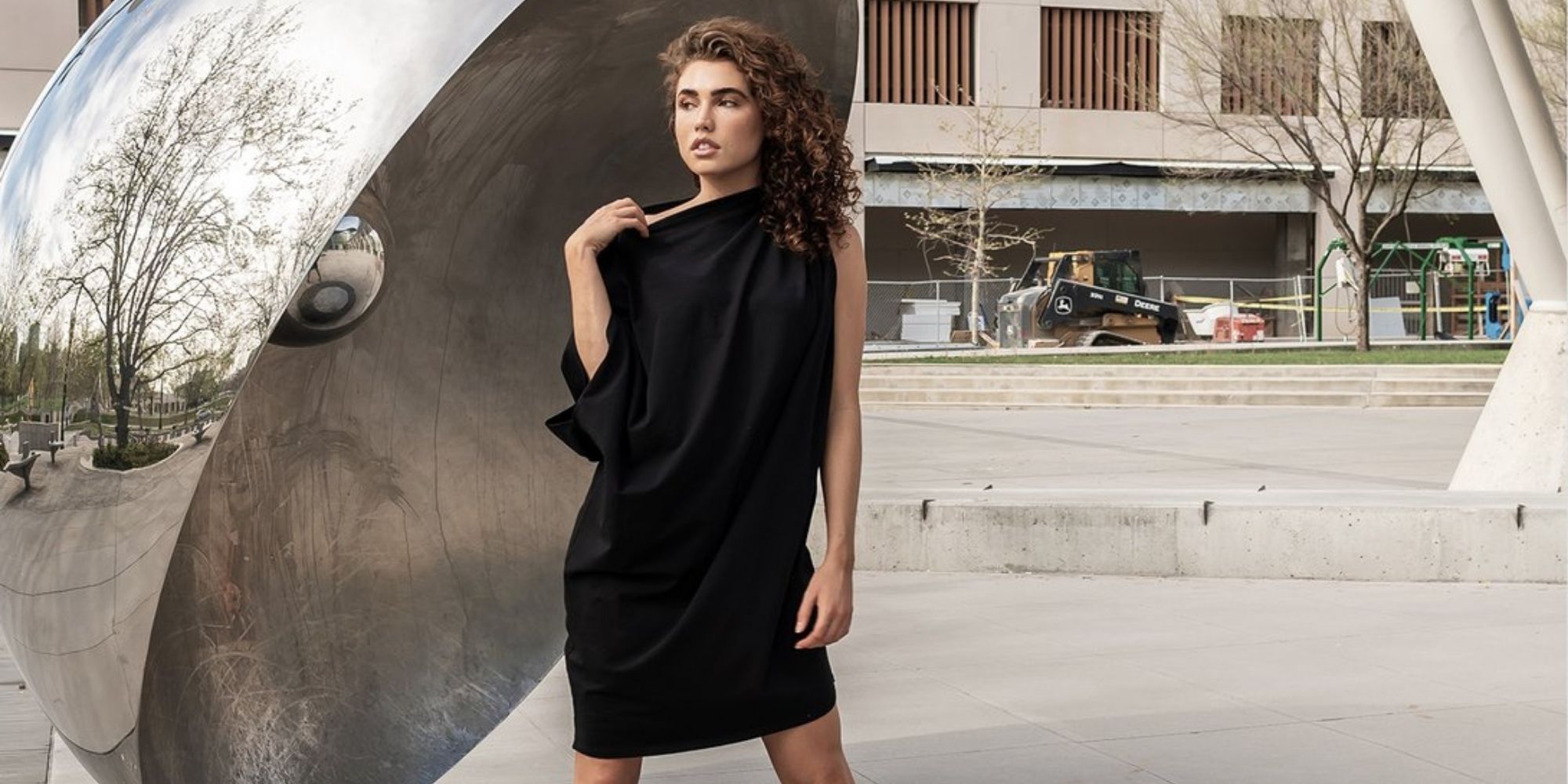 woman of colour wearing black zero waste dress by Malaika New York