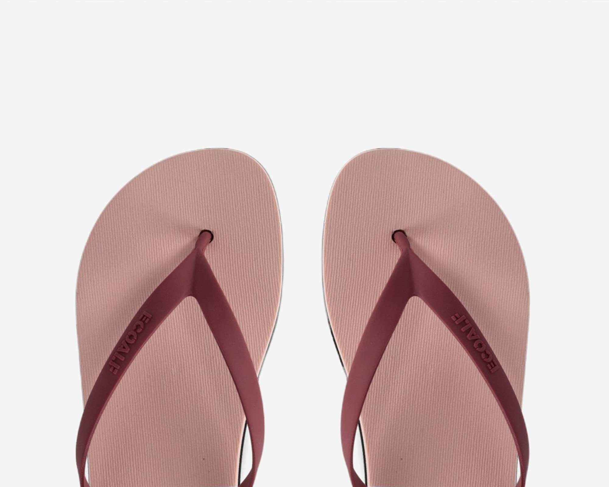 A close up of red and pink sustainable flip flops by Ecoalf.