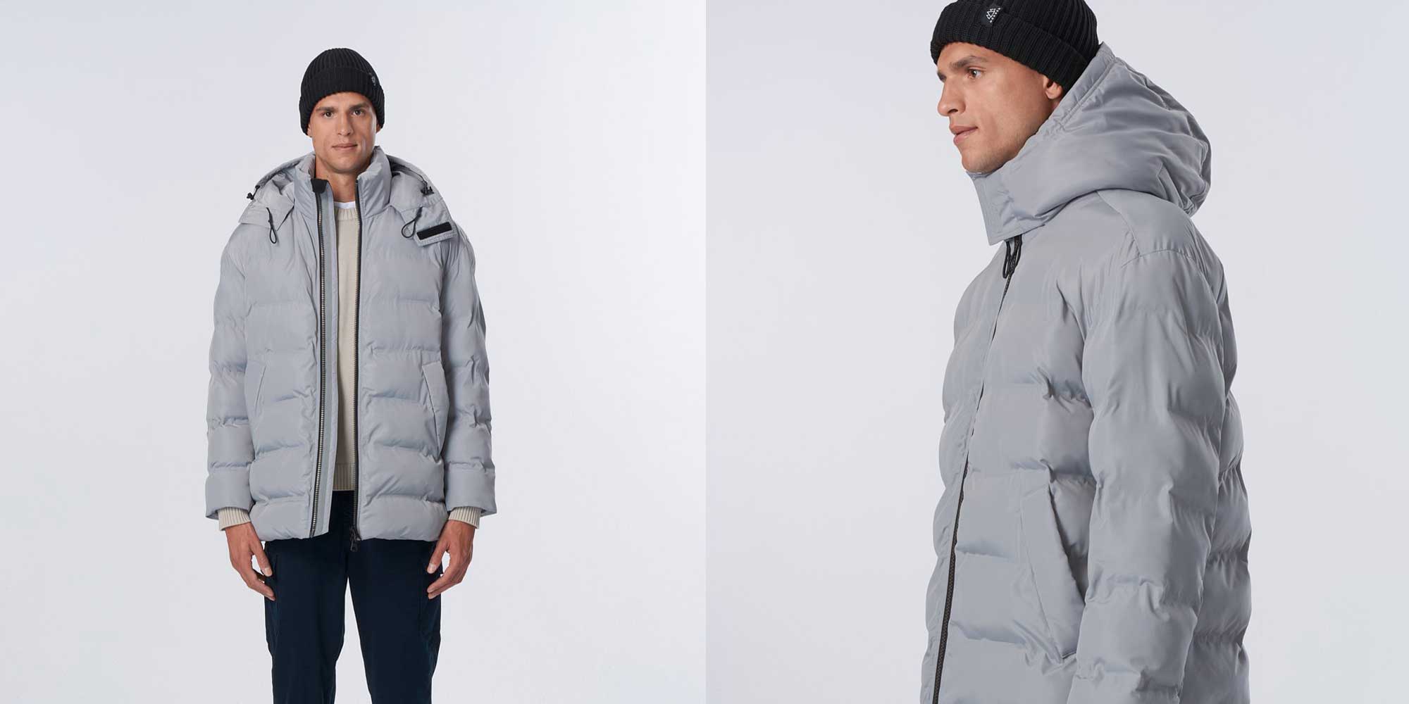 Person wearing grey puffer jacket by NORDEN