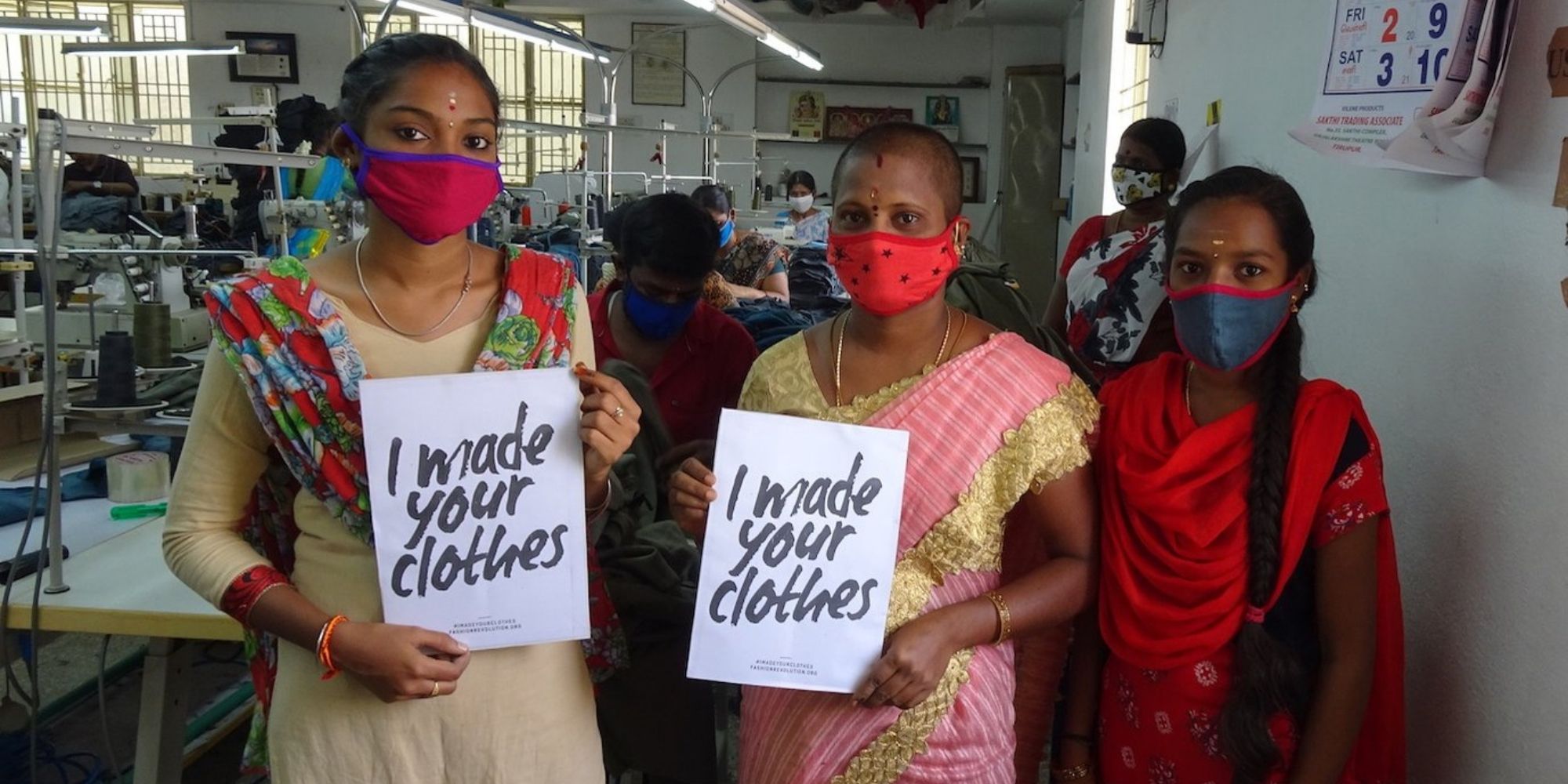 Group of garments workers holding up