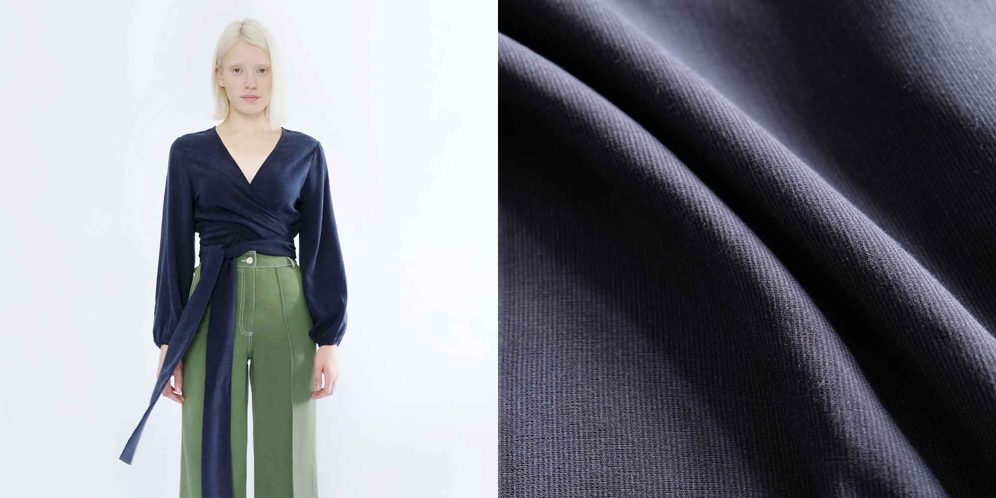 A blonde person wearing a blue balloon sleeve sustainable top by OhSevenDays.