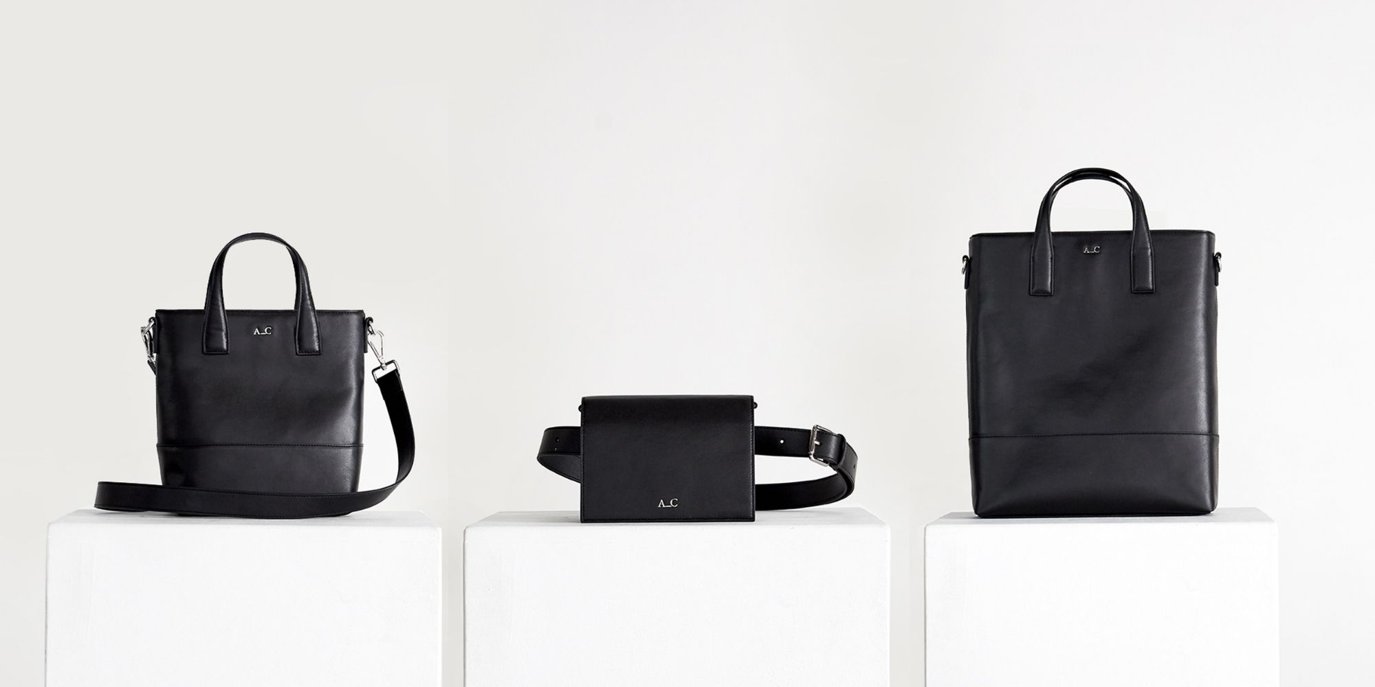 Product shot of three black vegan handbags side-by-side, ethically made by A_C.