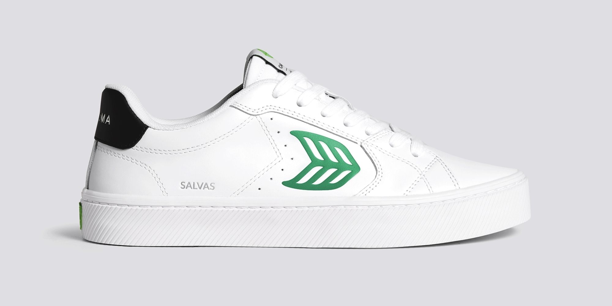 A close up of one white and green cleaner leather Salvas sneaker by CARIUMA.