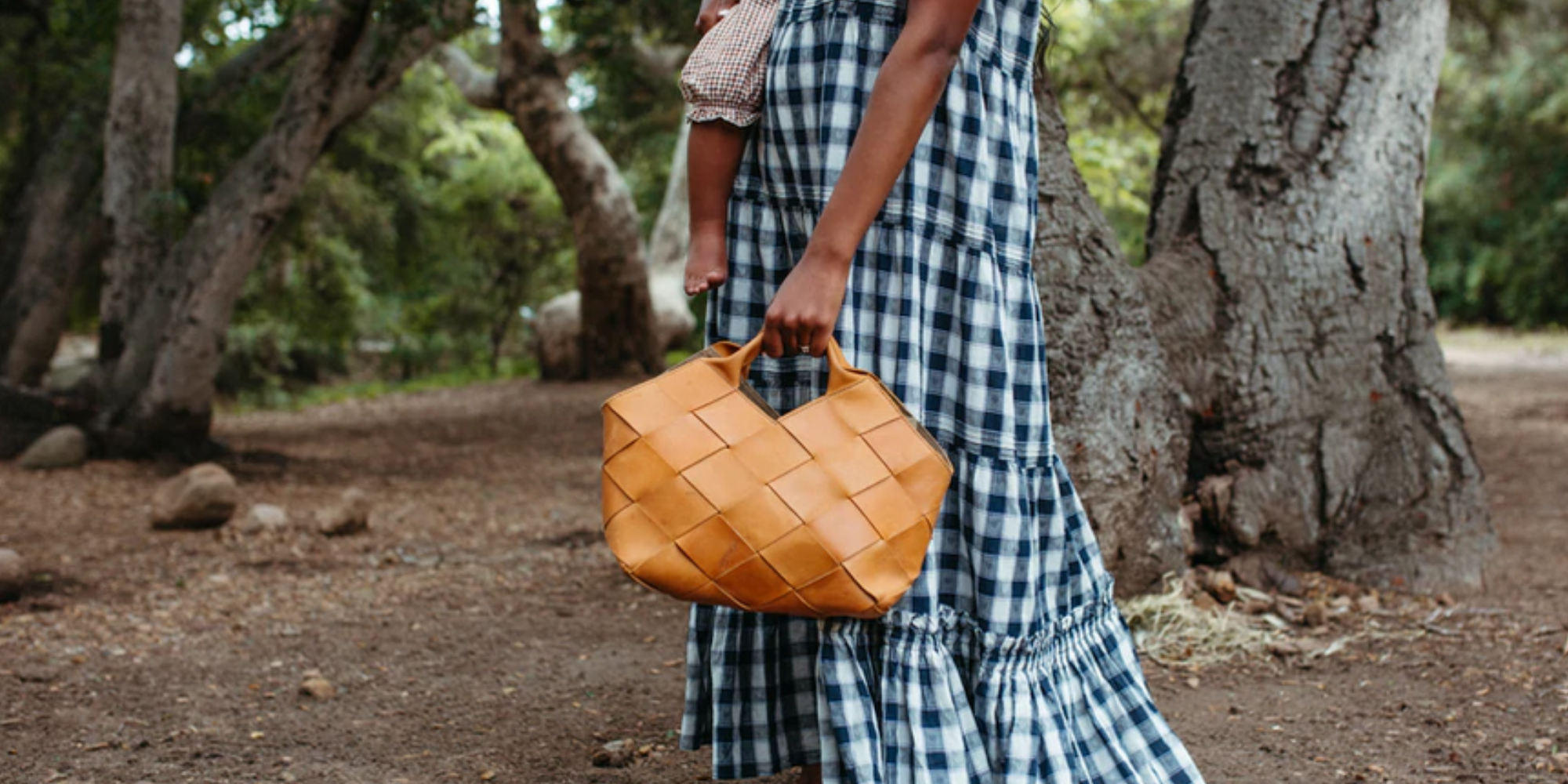 styled image of person holding Acacia woven bag from the Woven Collection by Parker Clay