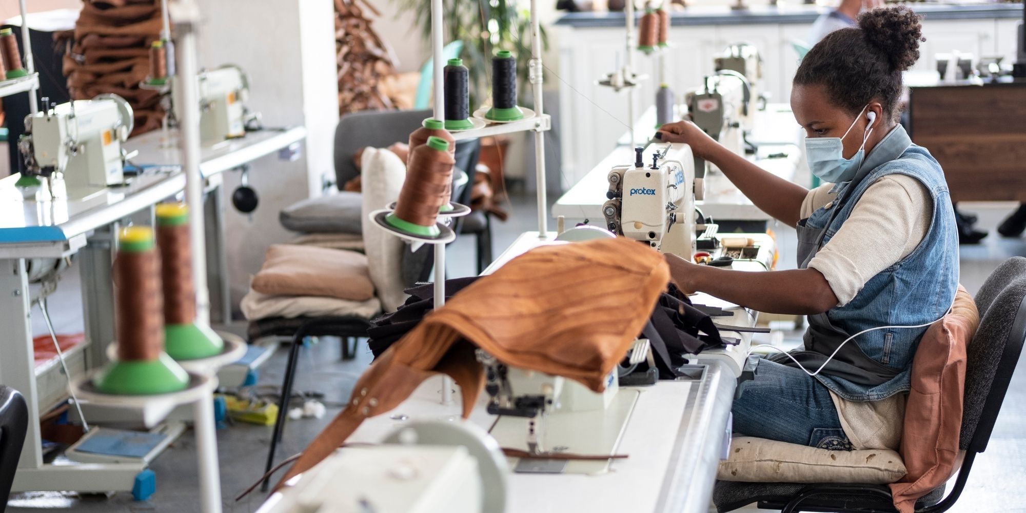 An artisan working on sewing leathergoods for Raven + Lily.