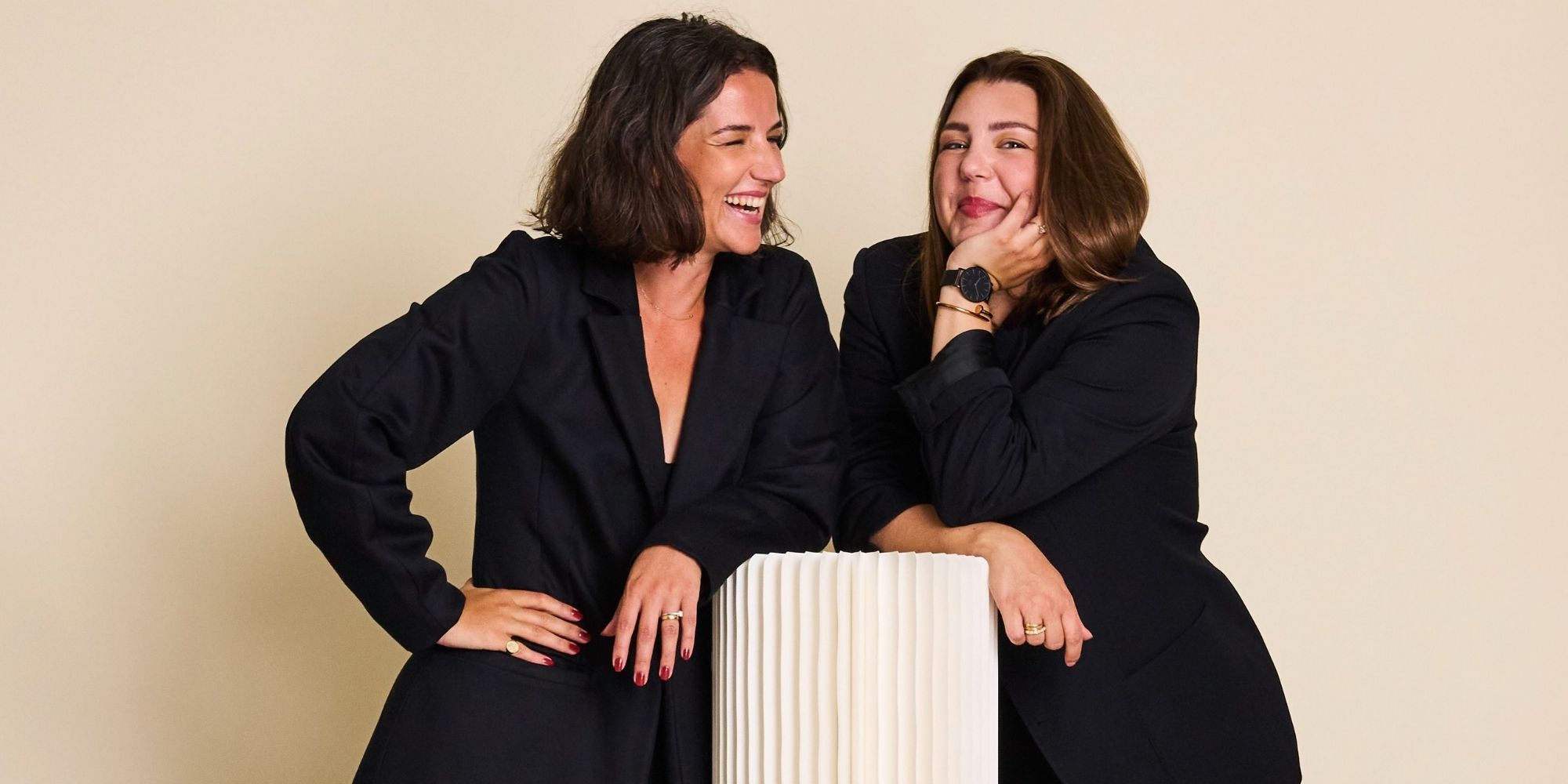 Two JAN 'N JUNE founders wearing all black and laughing together.