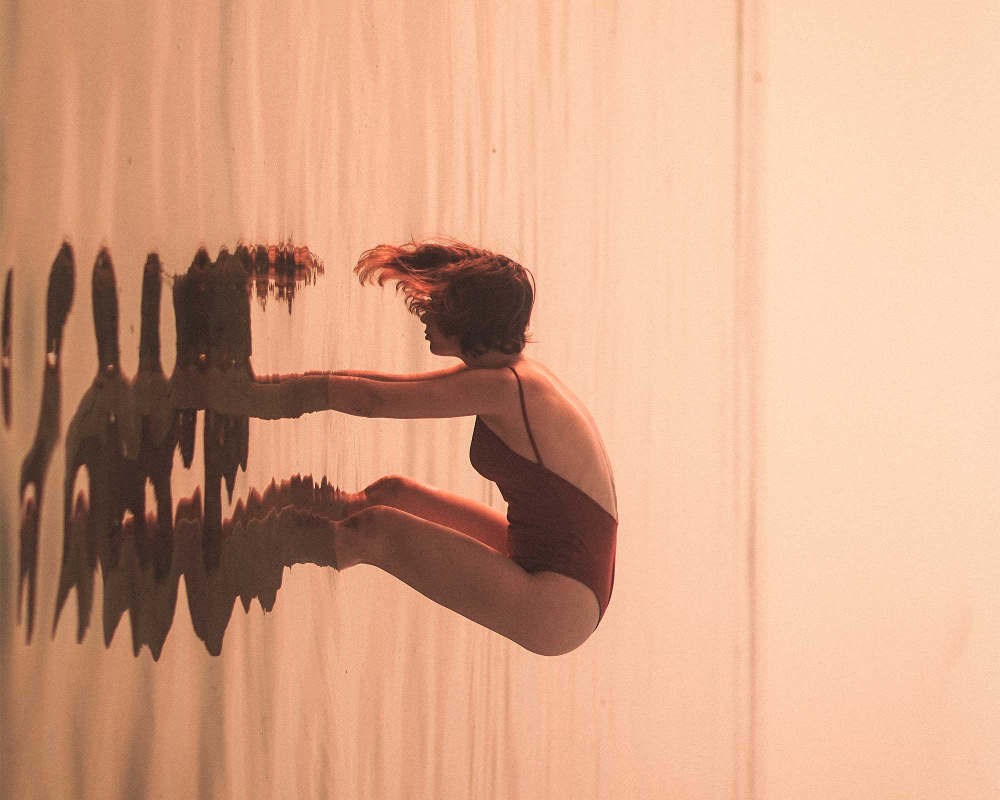 A person half immersed in water.