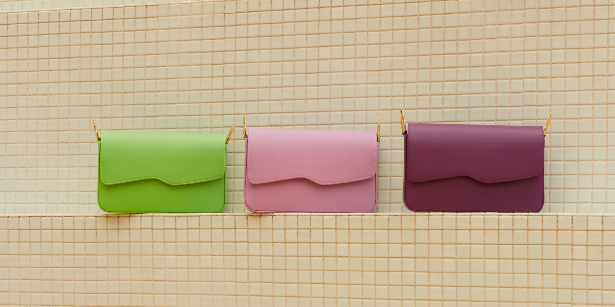 Three sustainable Mashu bags side by side, in lime green, light pink, and grape purple.