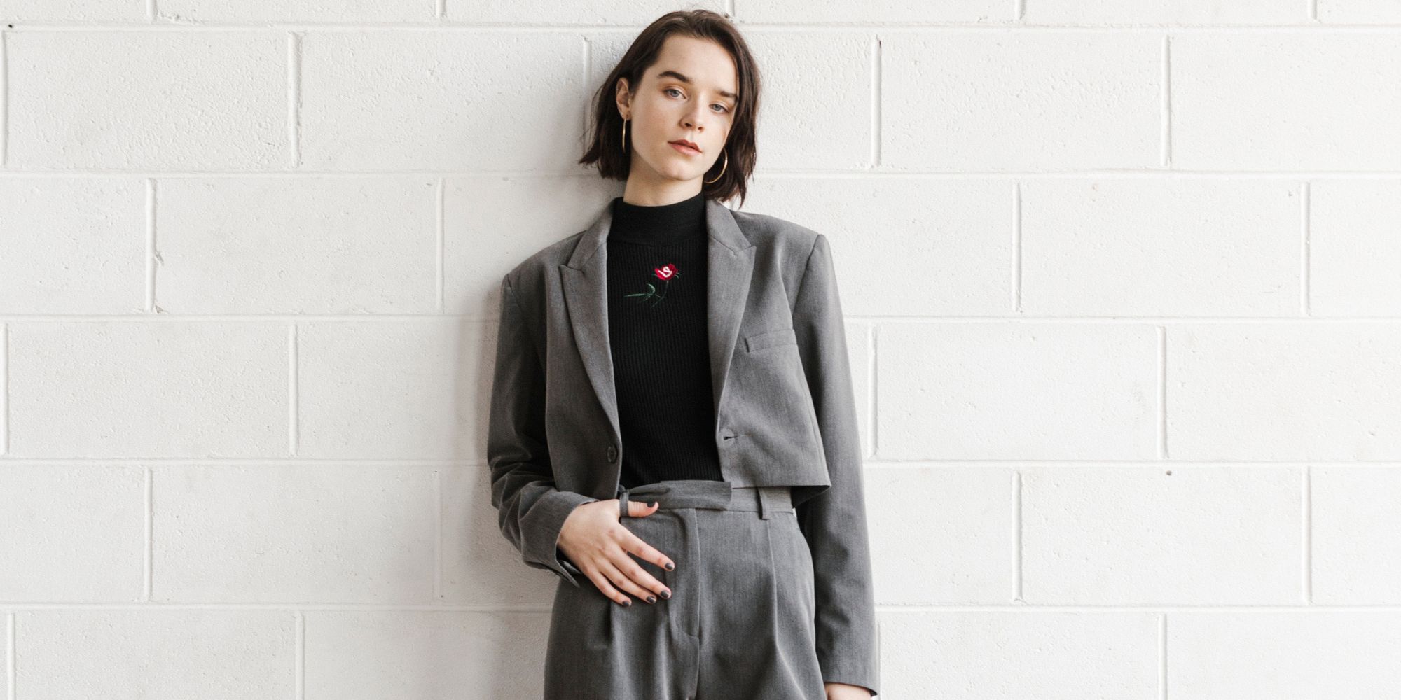 Author Emma Hakansson wearing a grey vegan co-ord suit set.