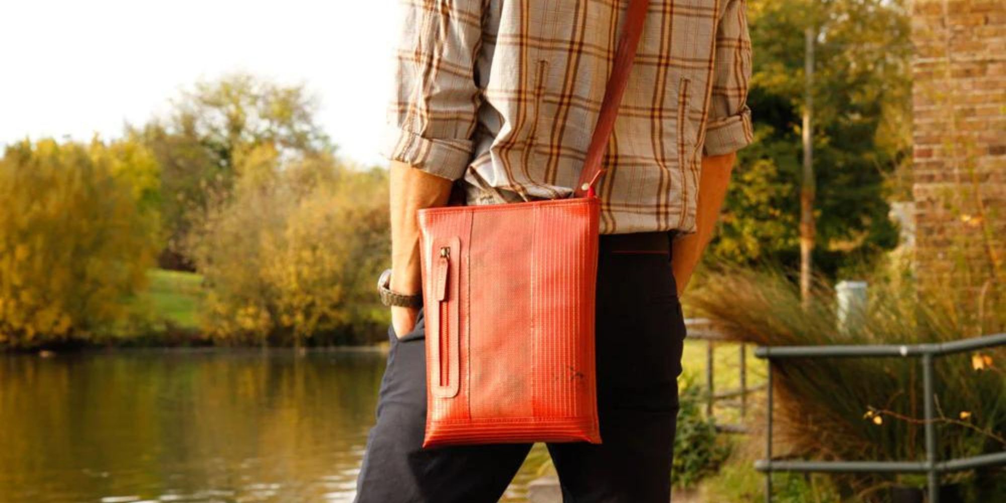 A red upcycled fire hose shoulder bag by Elvis & Kresse.