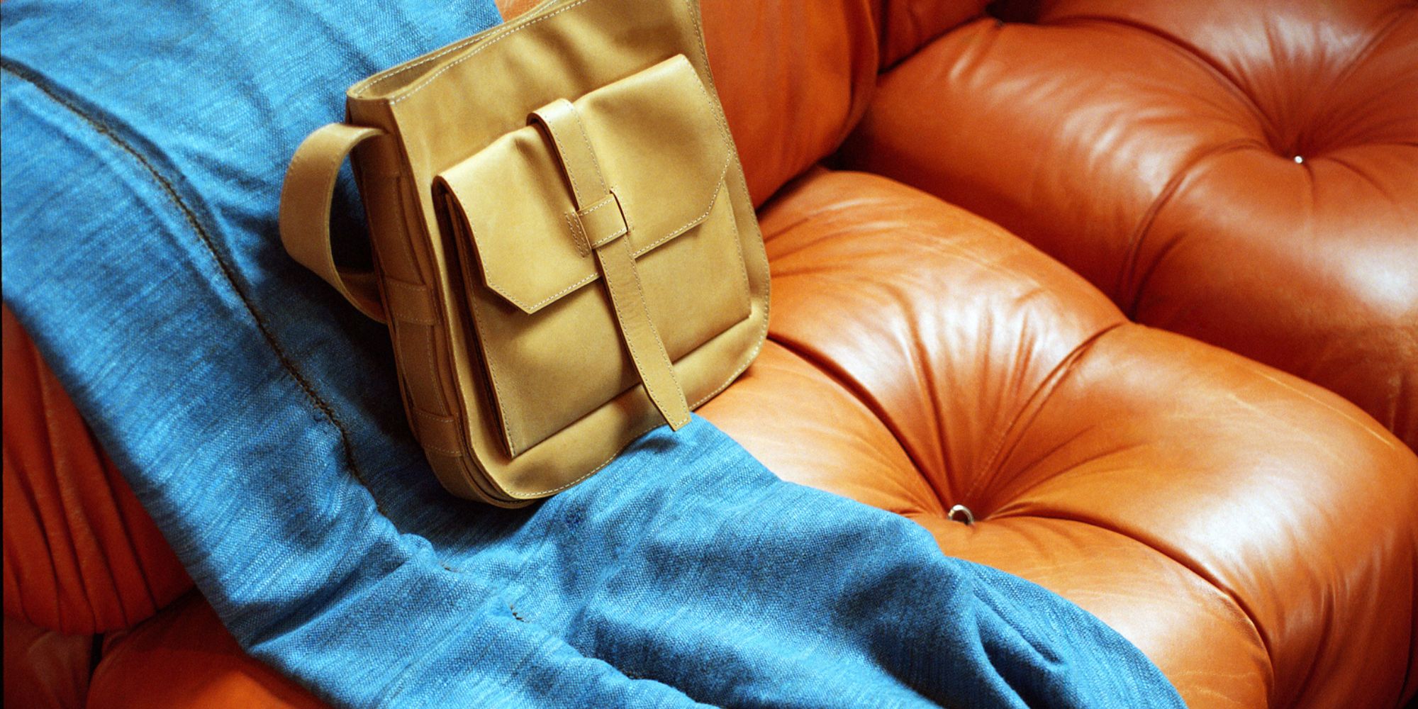 A blue throw blanket and yellow hobo handbag by Raven + Lily.