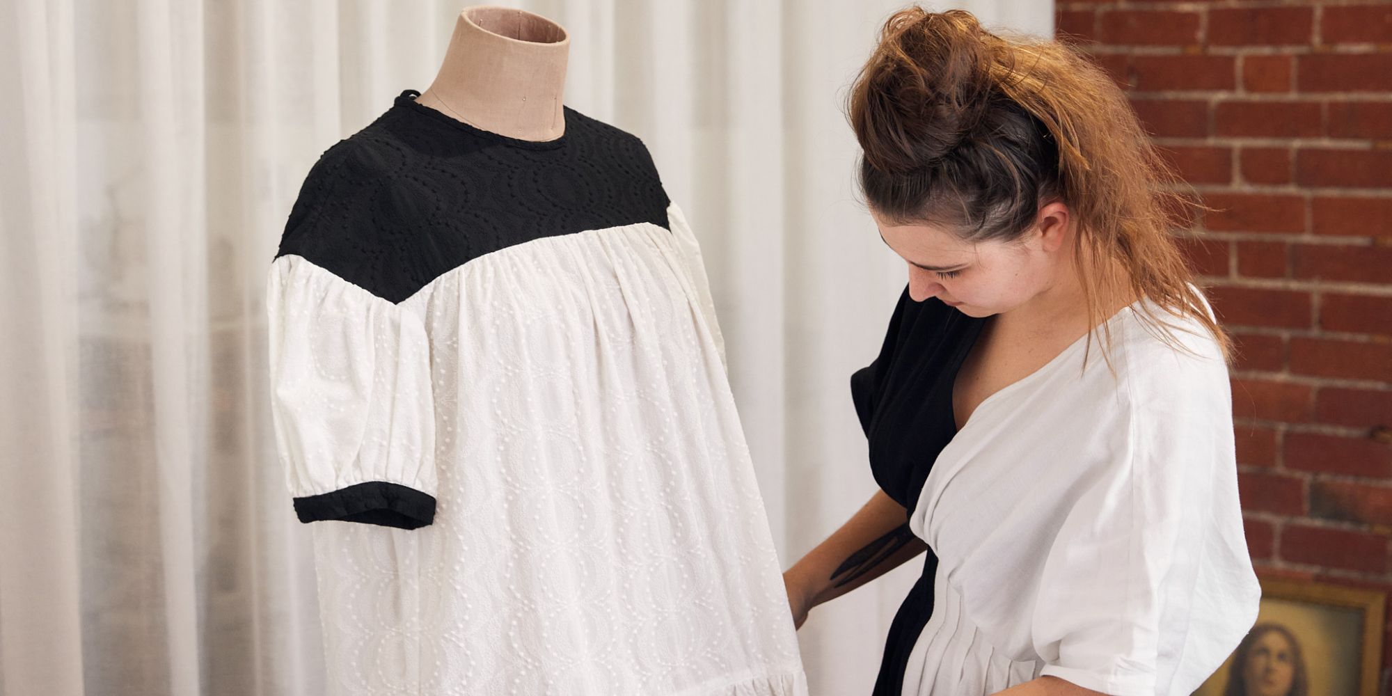 Kalaurie founder working on a black and white handmade dress in the brand's Melbourne atelier.