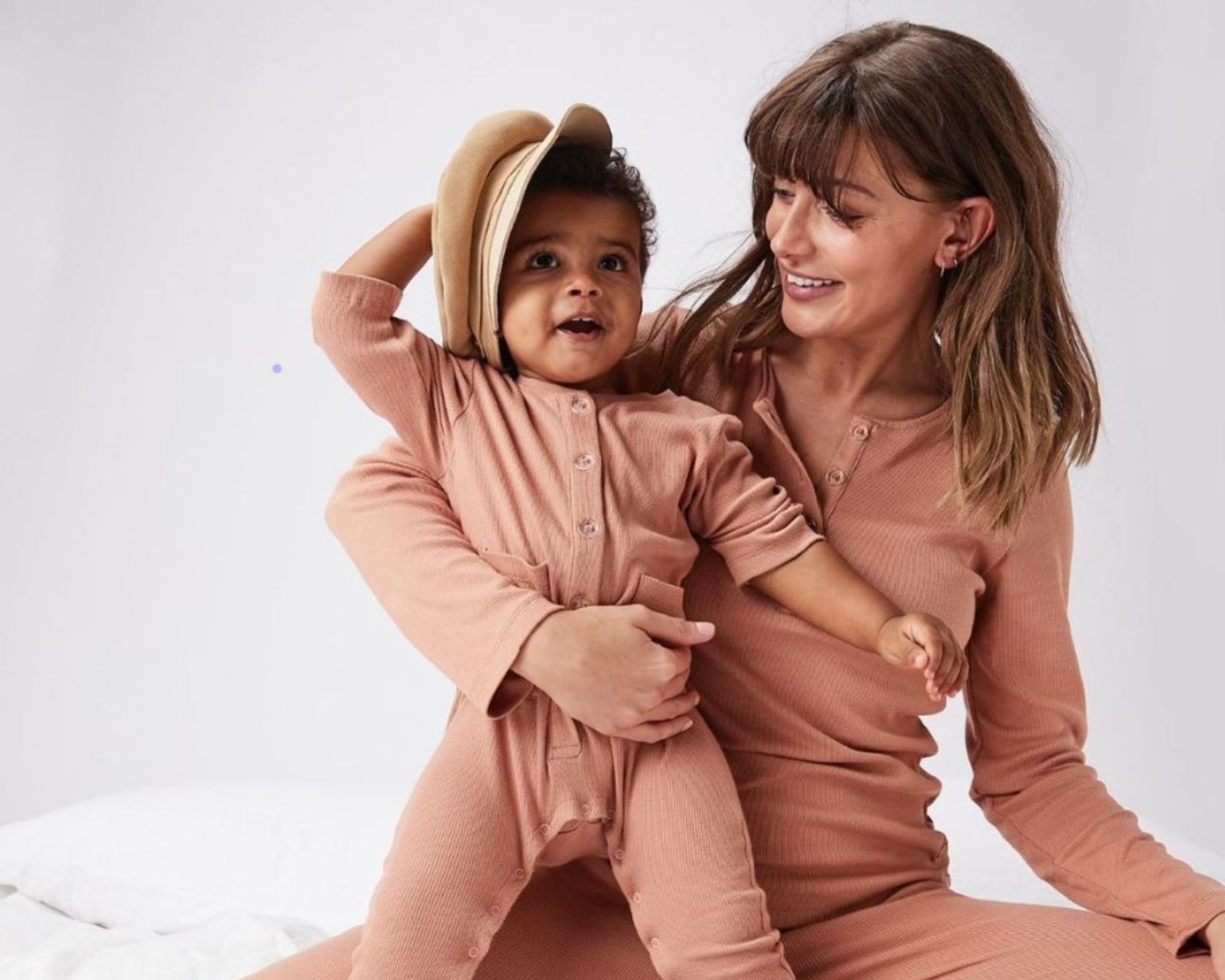 A mother and baby wearing matching pink body sets by Bow&Bo.
