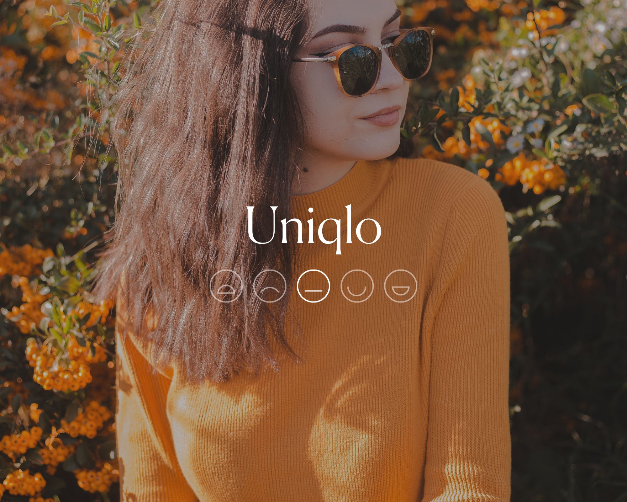Someone sitting in a field of flowers wearing sunglasses and a bright yellow sweater with the word Uniqlo and a flat line emoji face overlaid.