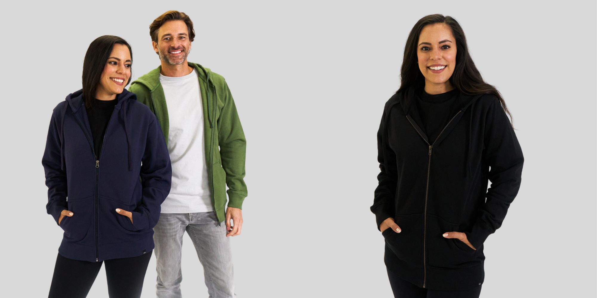 A navy blue, a green, and a black organic cotton zip up hoodie made by Terra Thread.