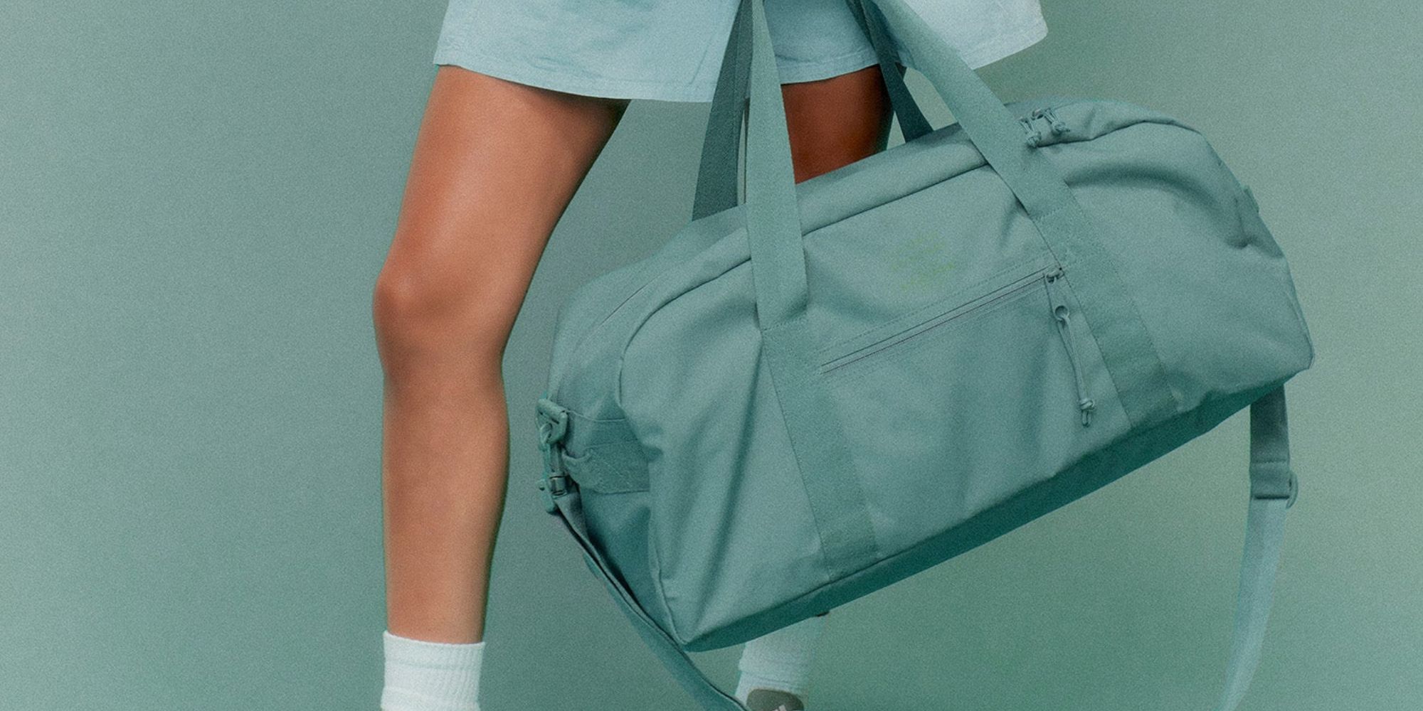 A mint coloured recycled plastic duffel bag made by Colorful Standard x Eastpak.