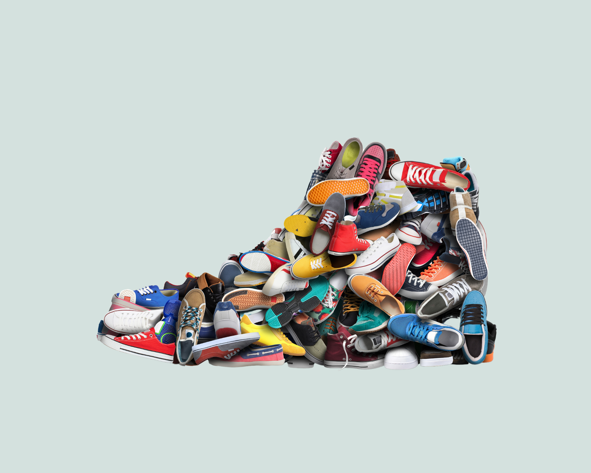 A massive stack of shoes takes the shape of one really big shoe
